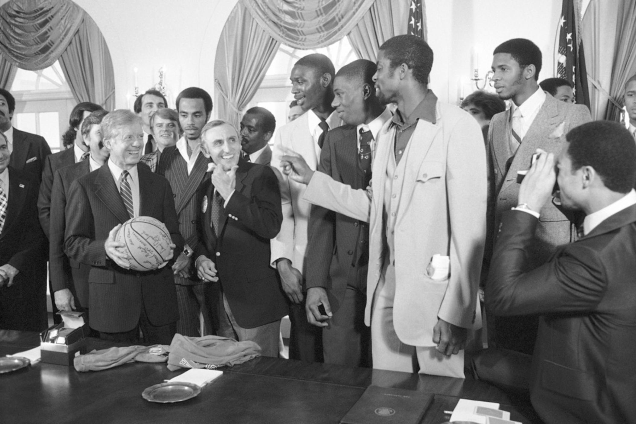 President Jimmy Carter holds a basketball presented to him by members of the University of Louisville basketball team at the White House in Washington on April 3, 1980. From left: President Carter; Darrel Griffith; Rep. Romana Mazzoli, D-Ky.; Derrick Smith; Wylie Brown and Darryl Cleveland. The NCAA Champs paid a visit to the White House after attending luncheon in their honor at Capitol Hill which was hosted by the Kentucky Congressional Delegation.
