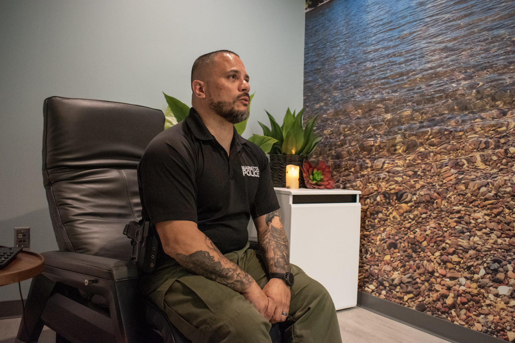 Marietta Police Department Sgt. Ray Figueroa sits in the headquarters’ new wellness room, which officers have dubbed the "Zen den." Departments across the country are placing more emphasis on officers’ mental health and well-being.