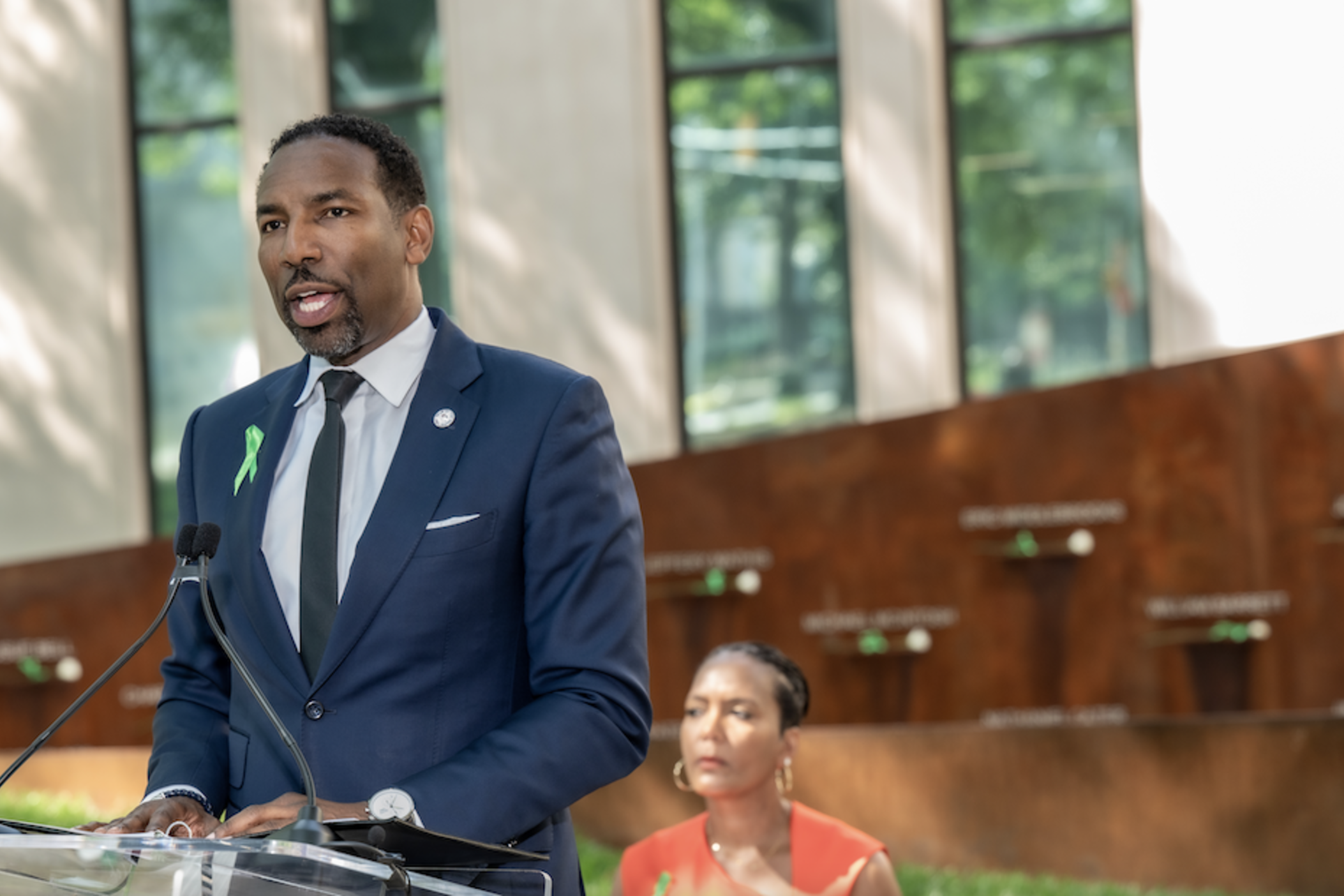 On the grounds of City Hall, Atlanta Mayor Andre Dickens speaks at the June 27, 2023 dedication of an eternity flame and memory wall in honor of victims of the Atlanta Child Murders as former mayor Keisha Lance Bottoms looks on.