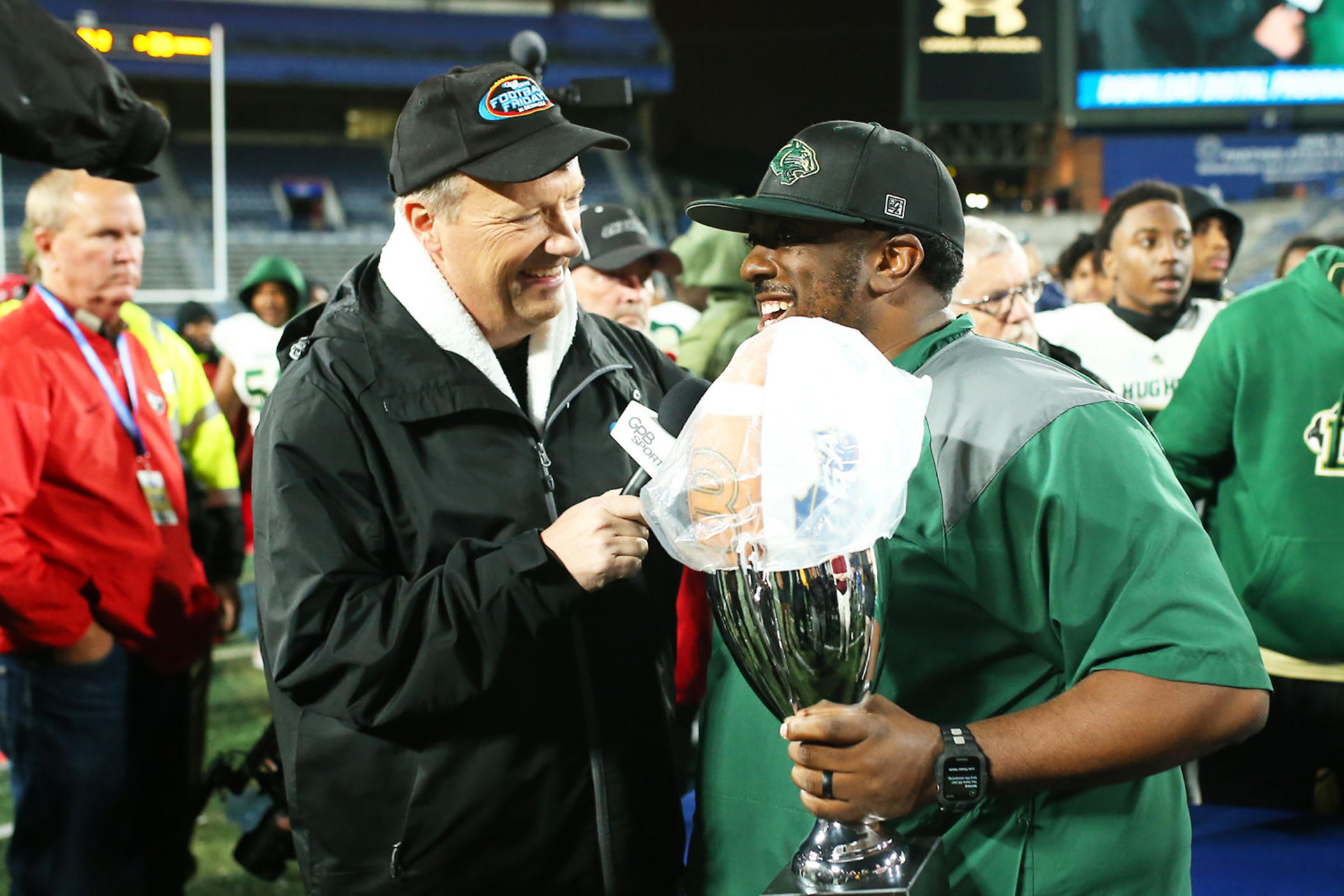 Hughes head Coach Boone Williams (right) and GPB reporter Jon Nelson doing a postgame interview after the Panthers won the 2022 GHSA 6A State Championship at Center Parc Stadium.