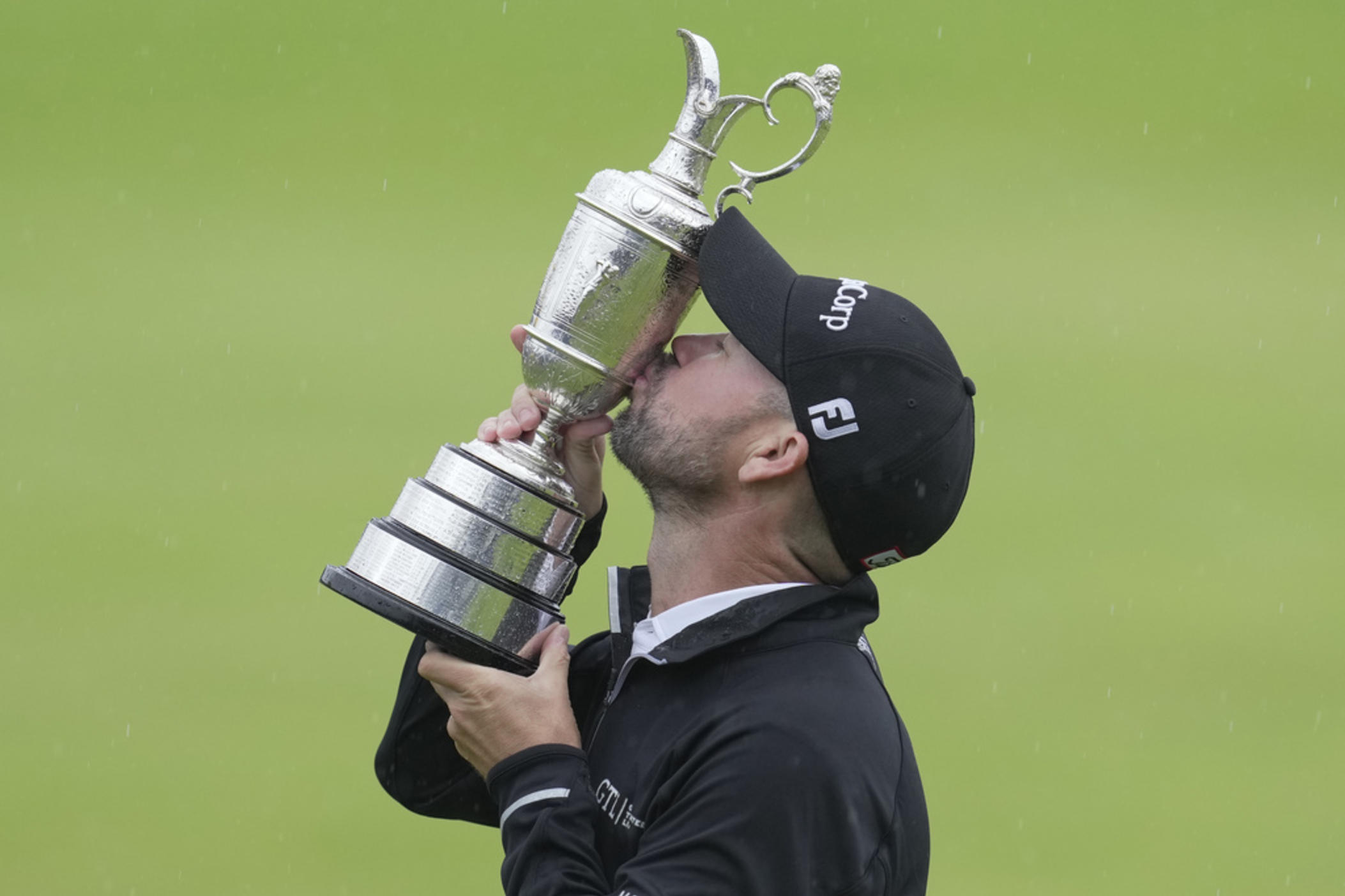 United States' Brian Harman kisses the trophy as he poses for the media holding the Claret Jug trophy for winning the British Open Golf Championships at the Royal Liverpool Golf Club in Hoylake, England, Sunday, July 23, 2023. 
