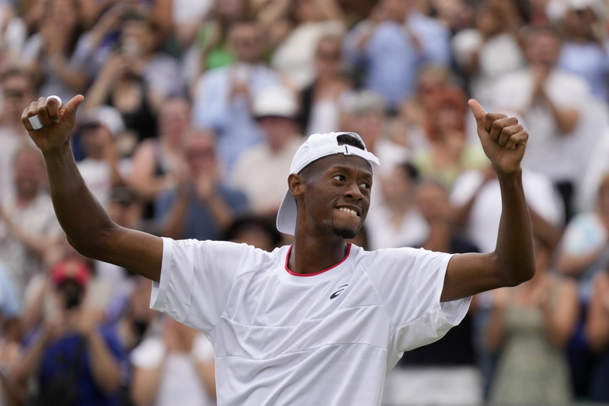 Christopher Eubanks of the U.S. celebrates after beating Stefanos Tsitsipas of Greece in a men's singles match on Day 8 of the Wimbledon tennis championships in London, Monday, July 10, 2023. 