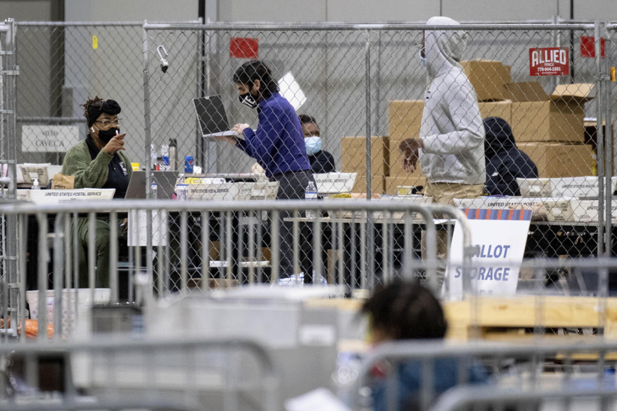 Fulton County, Ga., elections workers process absentee ballots for the Senate runoff election, Jan. 5, 2021, in Atlanta. The Republican Party in Georgia's most populous county, Fulton County, filed suit on Friday, June 30, 2023, against local elected officials over the rejection of one of the party's nominees to serve on the county election board, saying he was being punished for trying to clean up voter rolls.