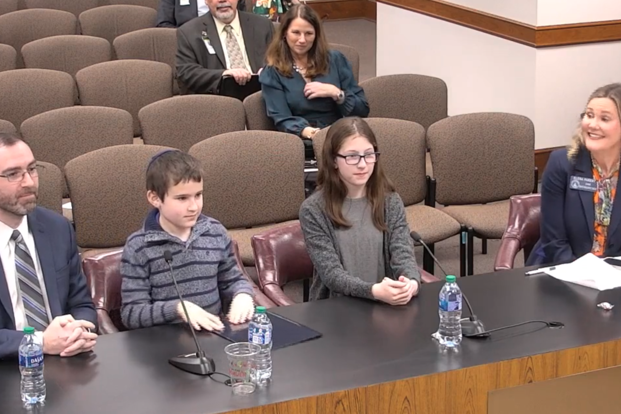 Rami Genauer (left) testifies in February 2023 before the Georgia Senate Committee on Economic Development and Tourism with his children Jack, 9, and Temima, 12, on Senate Bill 55, the “Georgia Lemonade Act.” Also pictured is state Sen. Elena Parent, the bill’s sponsor.