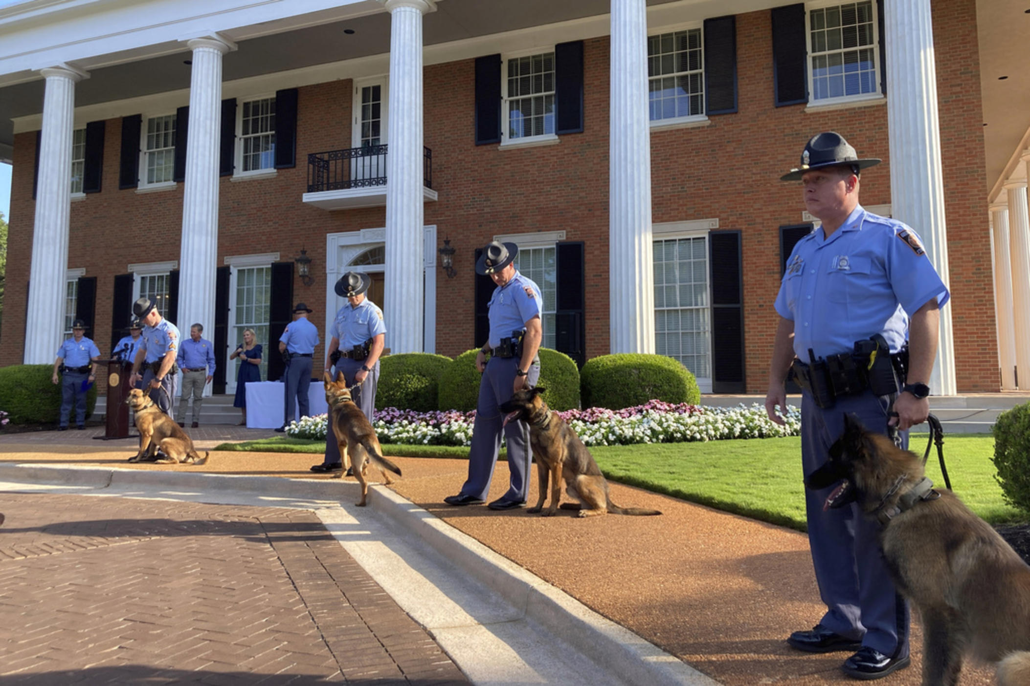 Police K-9s line up with their handlers before a graduation ceremony, Thursday, July, 13, 2023, at the governor's mansion in Atlanta. The Georgia Department of Public Safety welcomed 12 new dogs.