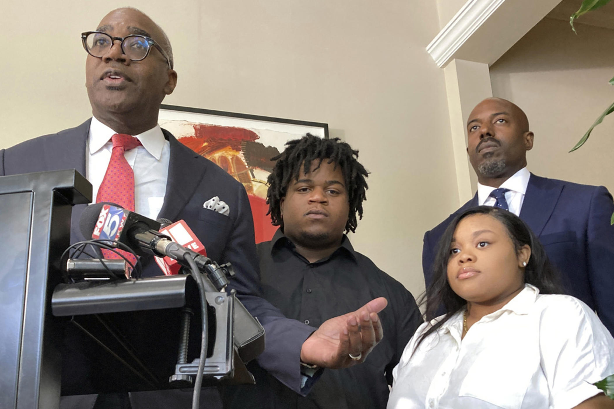 Attorney Roderick Edmond, from left, joined by Treveon Isaiah Taylor, Sr., Jessica Ross and attorney Cory Lynch, speaks during a news conference, Wednesday, Aug. 9, 2023, in Atlanta, announcing a lawsuit against a doctor and Southern Regional Medical Center, a hospital south of Atlanta where Ross went on July 9 to have her son. A doctor used too much force and decapitated Ross's baby during delivery according to the lawsuit filed Wednesday, the attorneys said.
