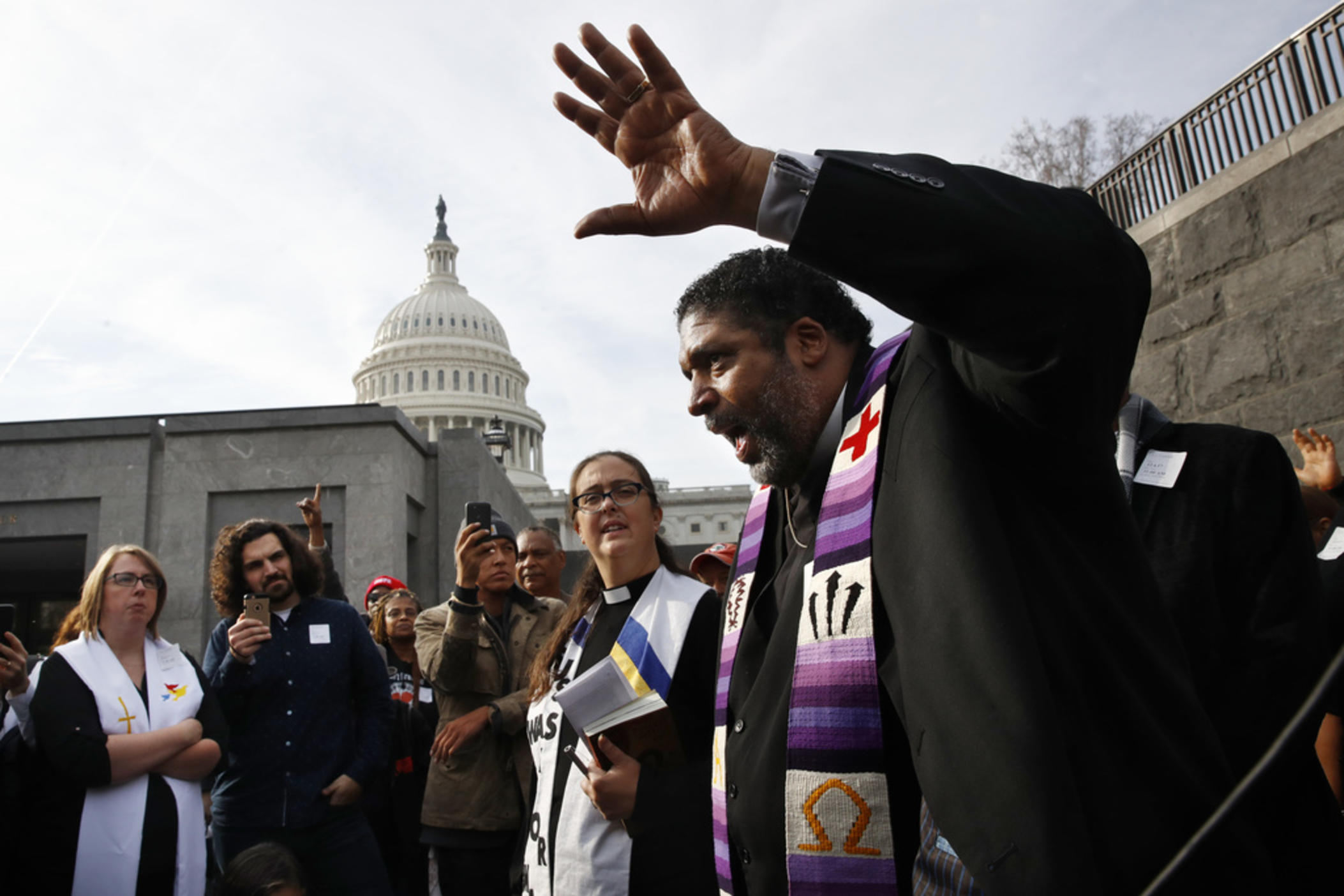 Rev. William Barber II, with the "Poor People's Campaign," speaks to the group after they prayed inside of the Capitol Rotunda in protest of the GOP tax overhaul, Monday, Dec. 4, 2017, on Capitol Hill in Washington. 