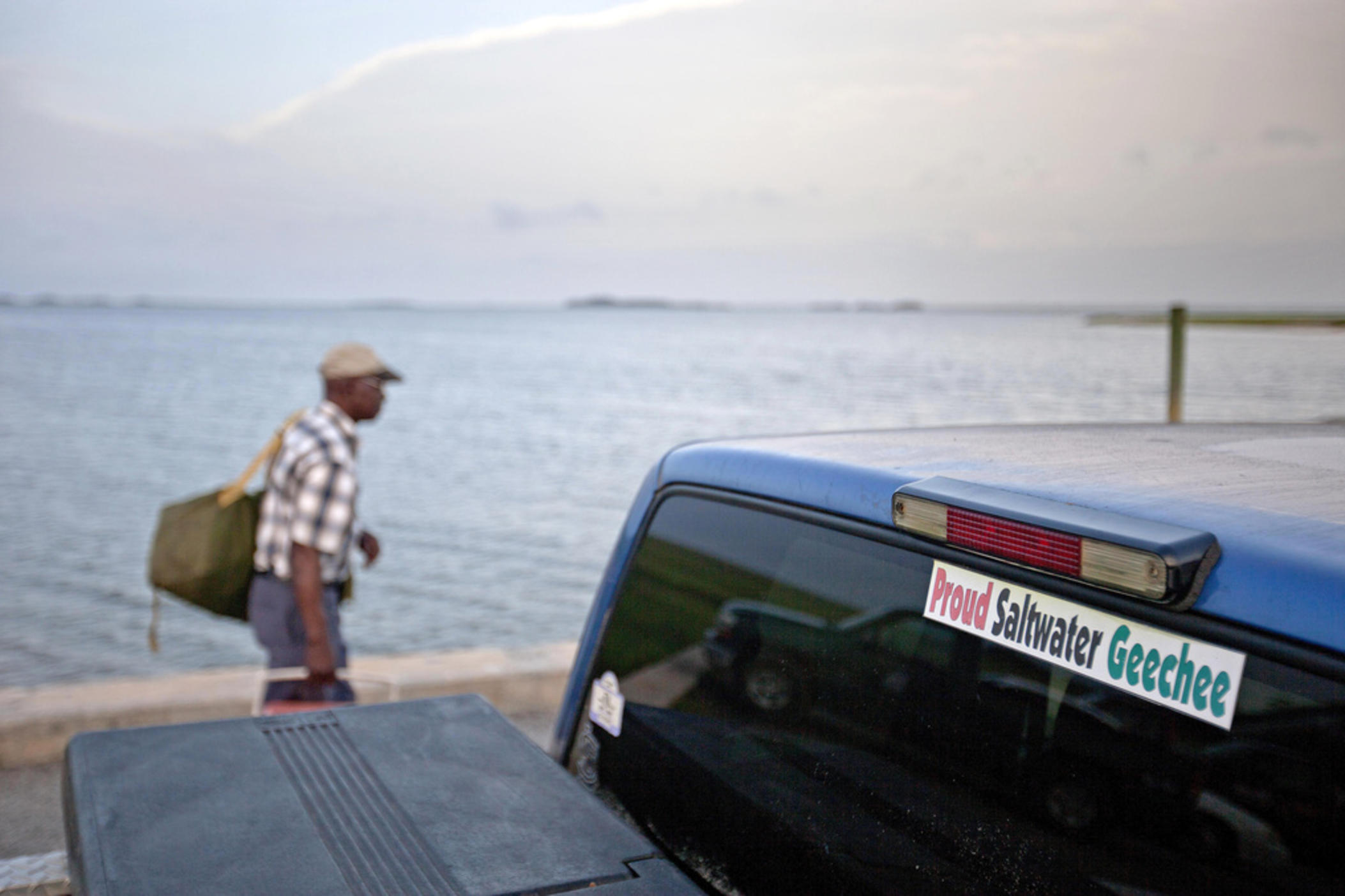 A sticker celebrating the Geechee heritage is seen on a pickup truck, June 10, 2013, as passengers board a ferry to the mainland from Sapelo Island, Ga.