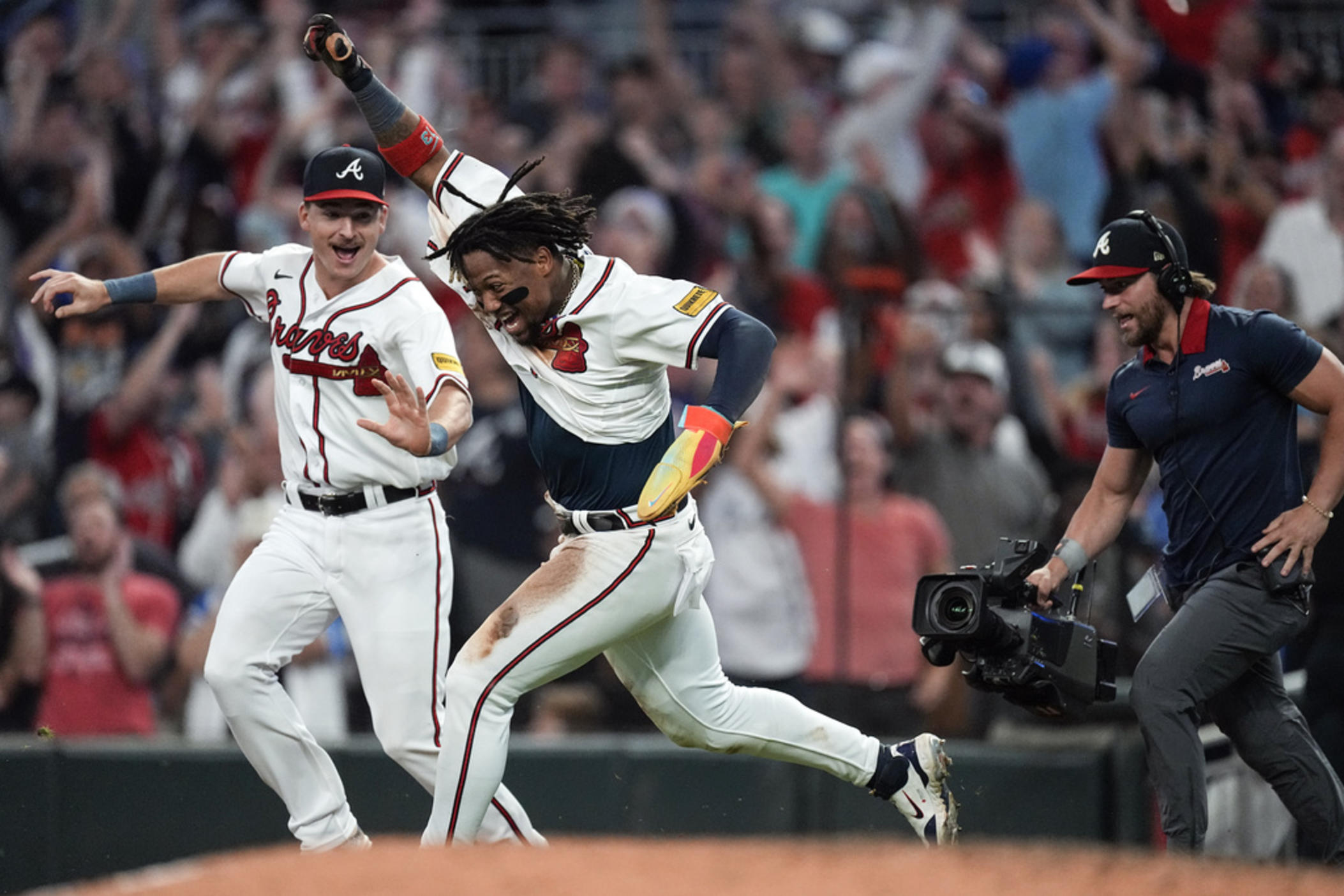 Atlanta Braves' Ronald Acuña Jr. celebrates after scoring the winning run on an Ozzie Albies base hit during the 10th inning of a baseball game against the Chicago Cubs, Wednesday, Sept. 27, 2023, in Atlanta. Acuña stole two bases in the game to become the first player in the majors to steal 70 bases and hit 40 home runs in a season.