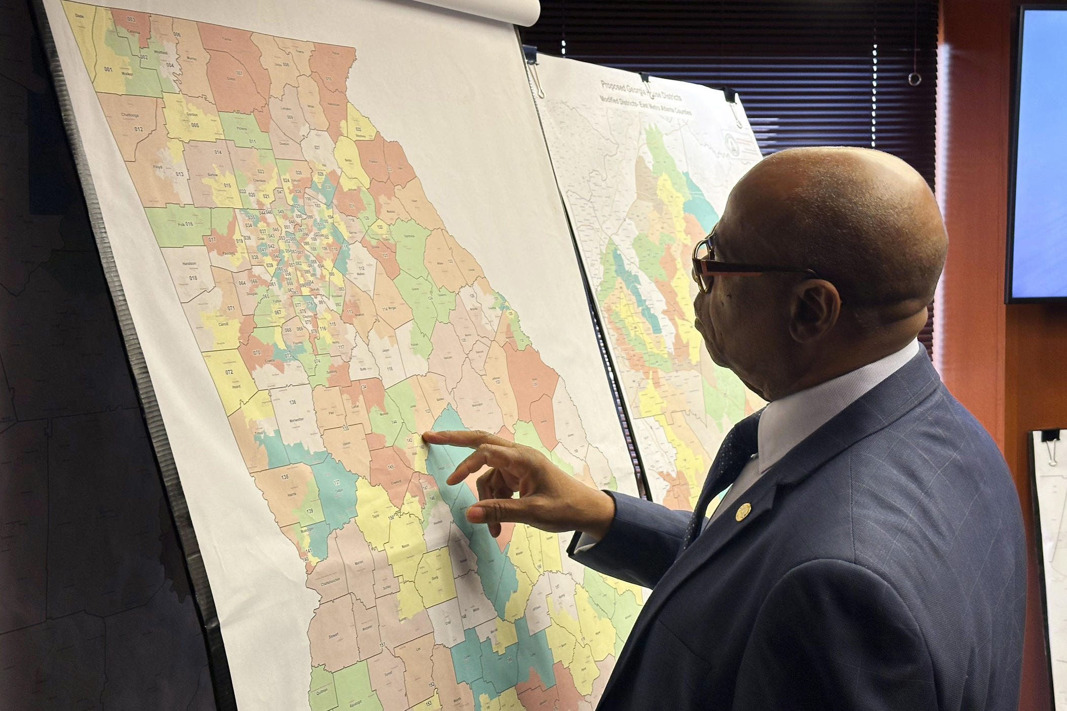 Georgia state Rep. Mack Jackson, D-Sandersville, looks at a map of proposed state House districts before a House hearing, Wednesday, Nov. 29, 2023, at the Georgia Capitol in Atlanta. State lawmakers were ordered to redraw Georgia's legislative and congressional districts after a federal judge ruled some illegally diluted Black voting strength. (AP Photo/Jeff Amy)