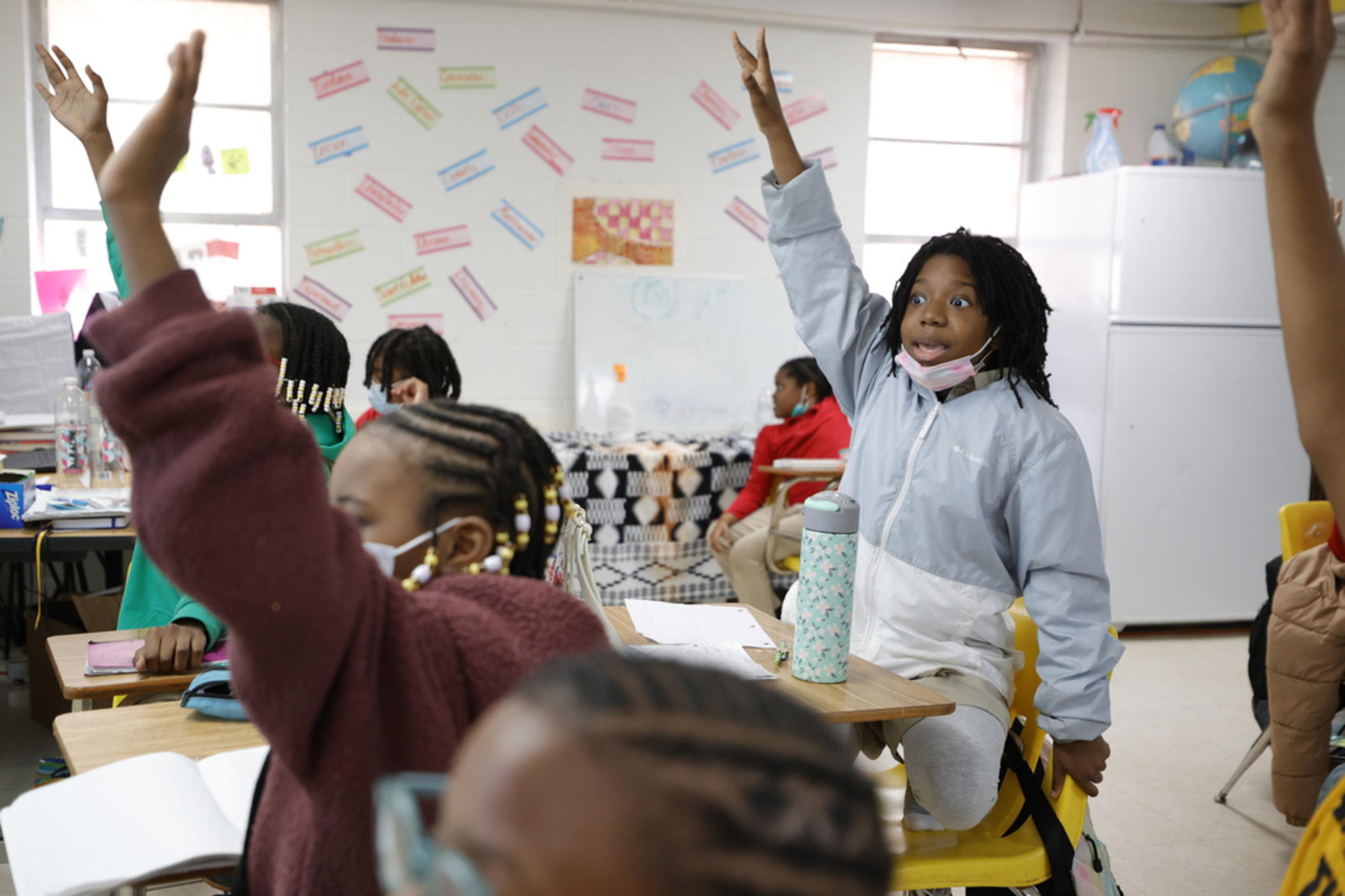 Zeniyha Howard, 10, of Decatur, Ga., raises their hand during a math lesson at the Kilombo Academic and Cultural Institute, Tuesday, March 28, 2023, in Decatur, Ga. 