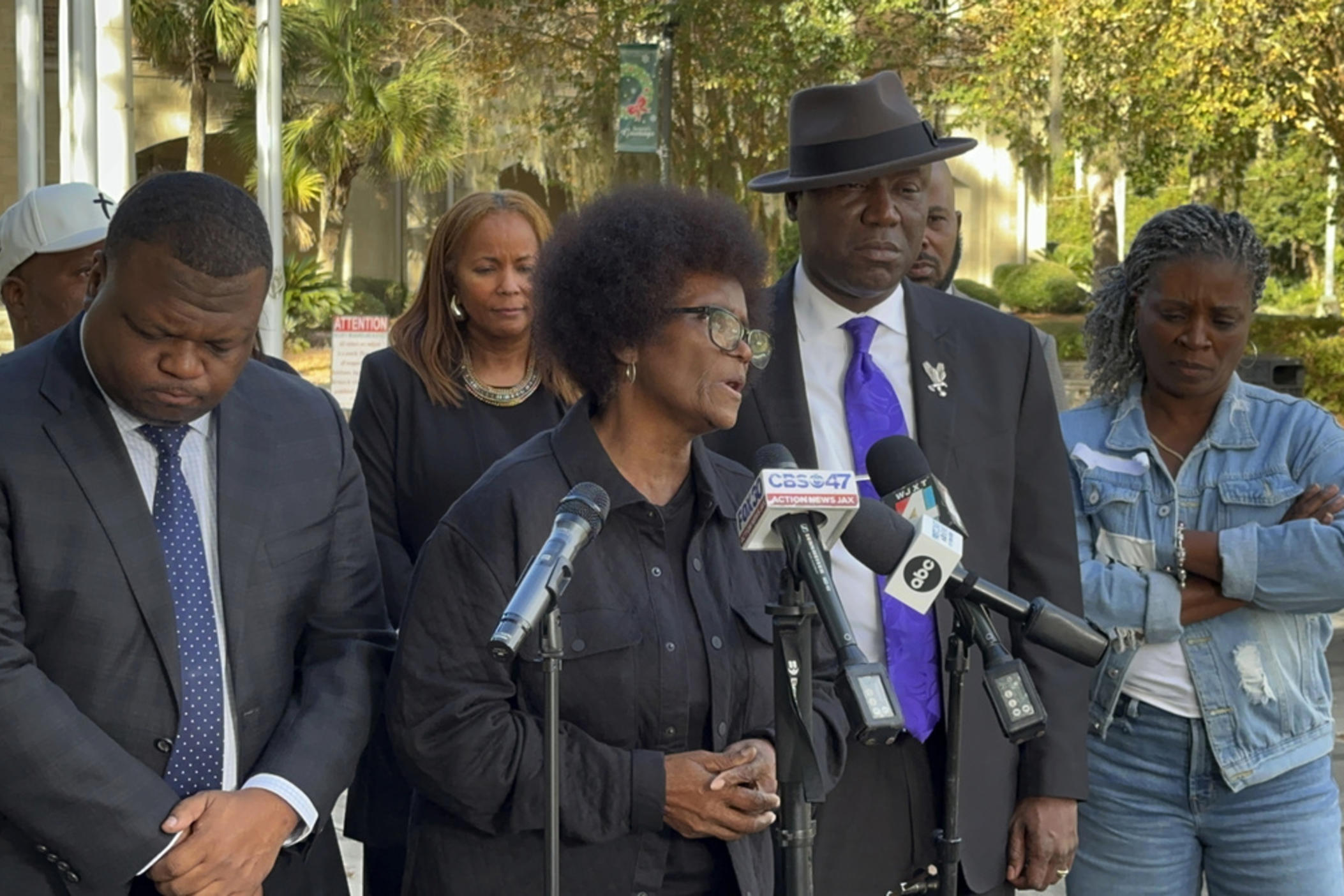 Mary Cure speaks to reporters flanked by her family's attorneys, Harry Daniels, left, and Ben Crump, right, at a news conference Tuesday, Dec. 5, 2023, in Woodbine, Georgia, announcing their intention to file suit against the Camden County Sheriff's Office for the death of her son, Leonard Cure. A deputy fatally shot Leonard Cure after pulling him over on suspicion of speeding and reckless driving, Oct. 17, 2023. 