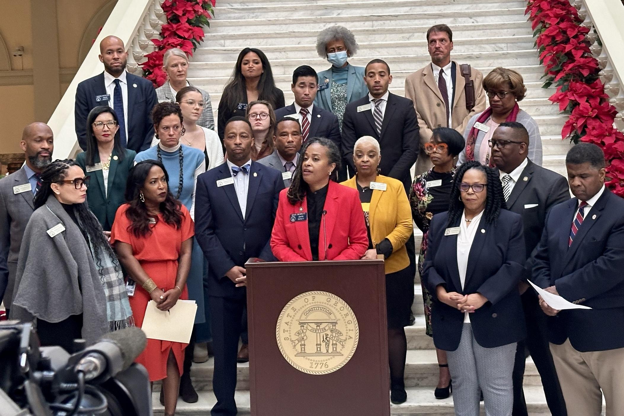 State Sen. Nikki Merritt, vice chair of the Georgia Legislative Black Caucus, speaks at the podium during a conference to protest the Republican redistricting maps presented during the Georgia General Assembly special session on Dec. 5, 2023.