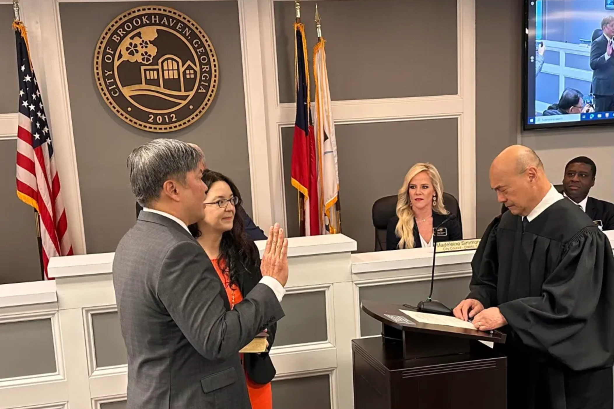 Brookhaven, Ga. mayor John Park being sworn in with his wife, Morgan Harris, at his swearing in on Jan. 8, 2024.