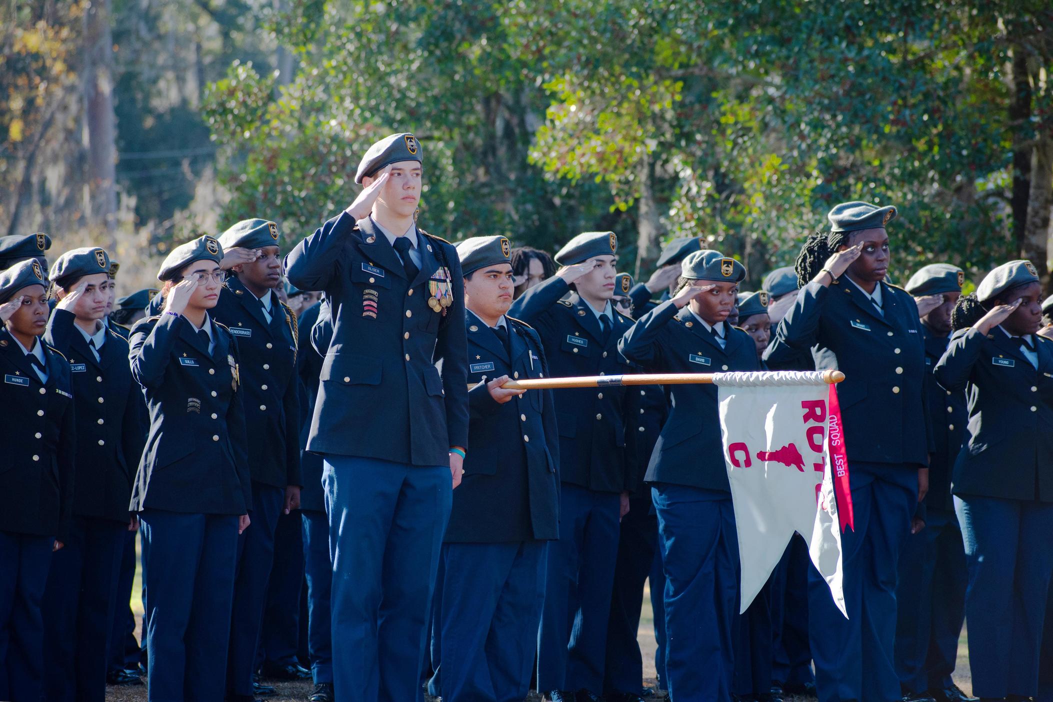 Members of JROTC at Savannah's Windsor Forest High School salute during a memorial for one of their former members, Breonna Moffett, an Army Reservist killed in Jordan in late January.