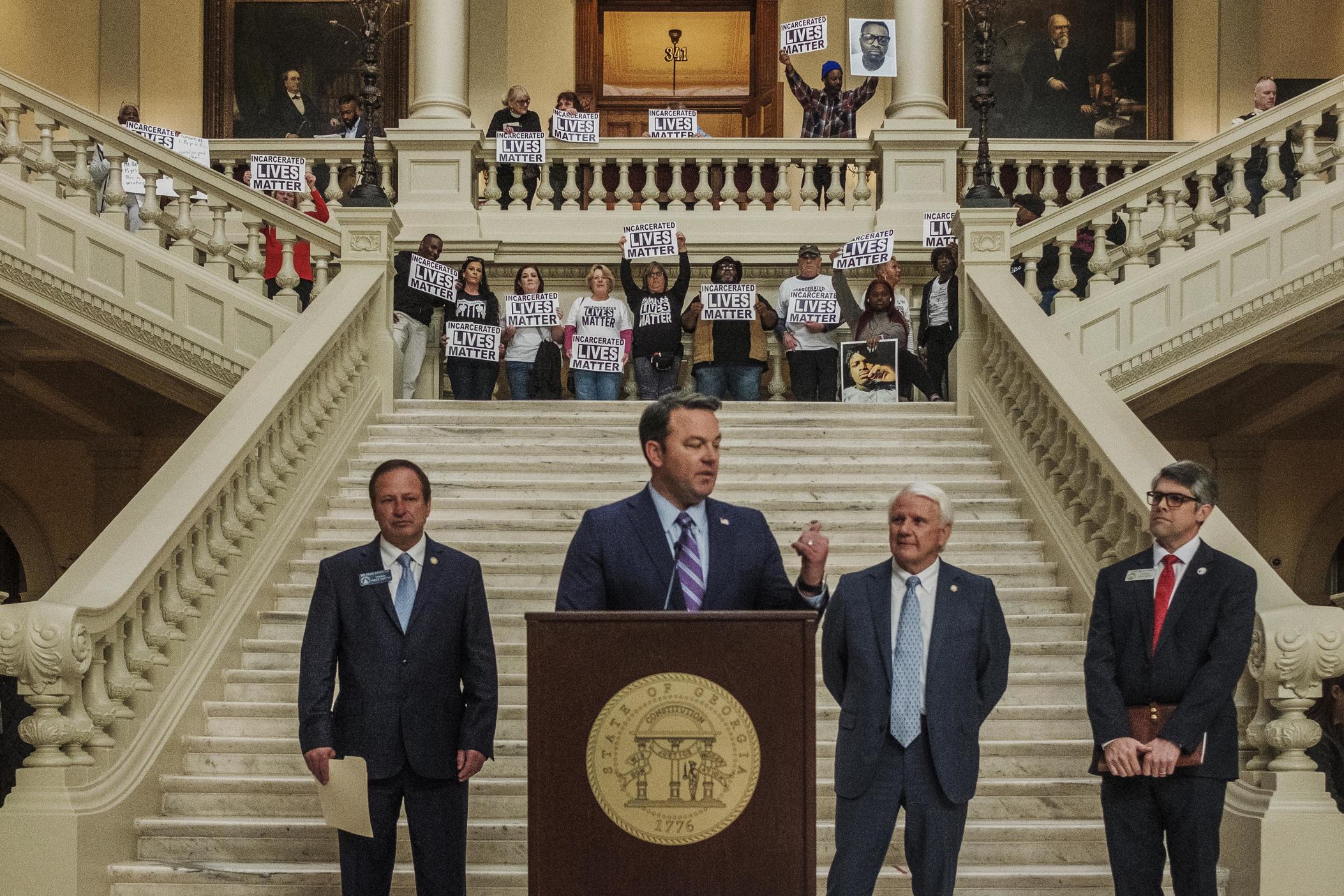 Prison rights advocates stage behind a press conference about tax reform in the rotunda of the Georgia State Capitol in early February. The group came to the capitol with hopes of getting the ears of legislators. 