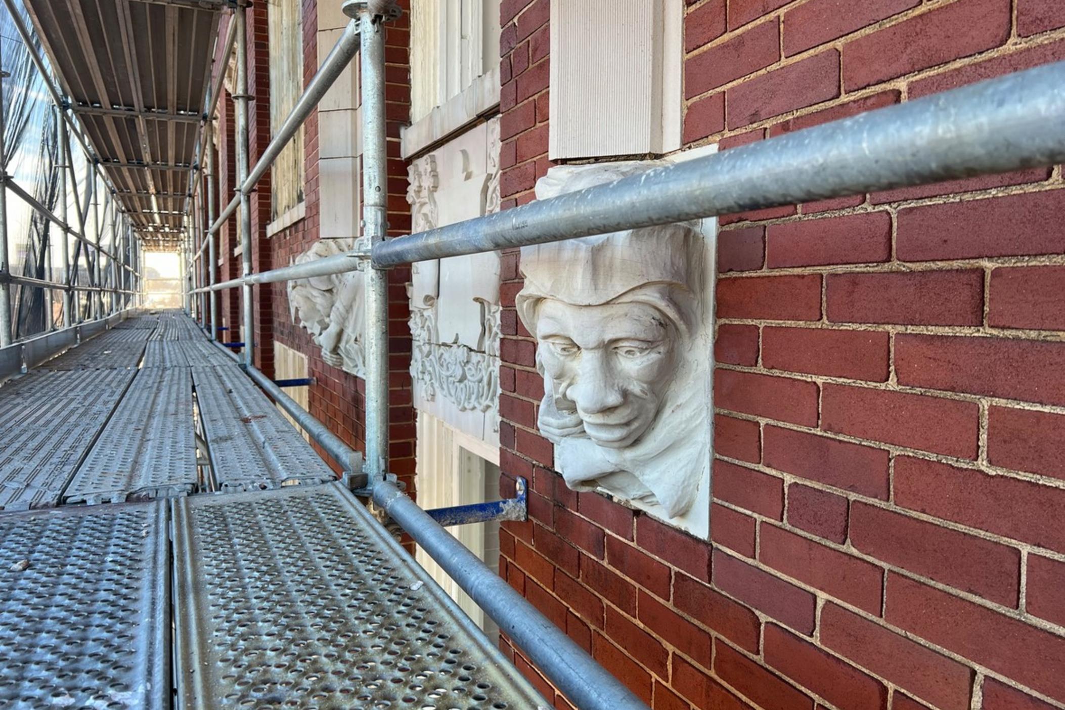 The Odd Fellows Building is two stories with an adjacent six-story office tower and distinctive heads with African-American features.