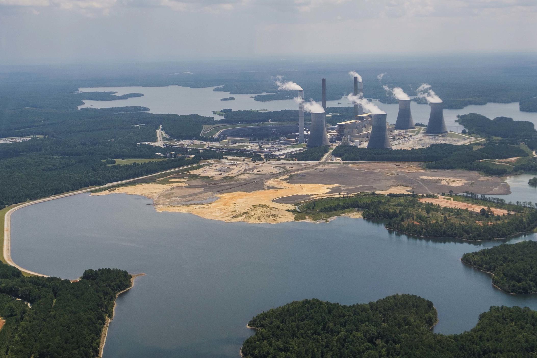 Until 2020, when coal was burned at Georgia Power's Plant Scherer, the remaning toxic ash is sunk into the body of water in the foreground. An underground stream flows through that ash at depths of up to 25 feet and out the massive ash pond. Georgia Power's plan for closing that pond would keep much of the coal ash in that state.