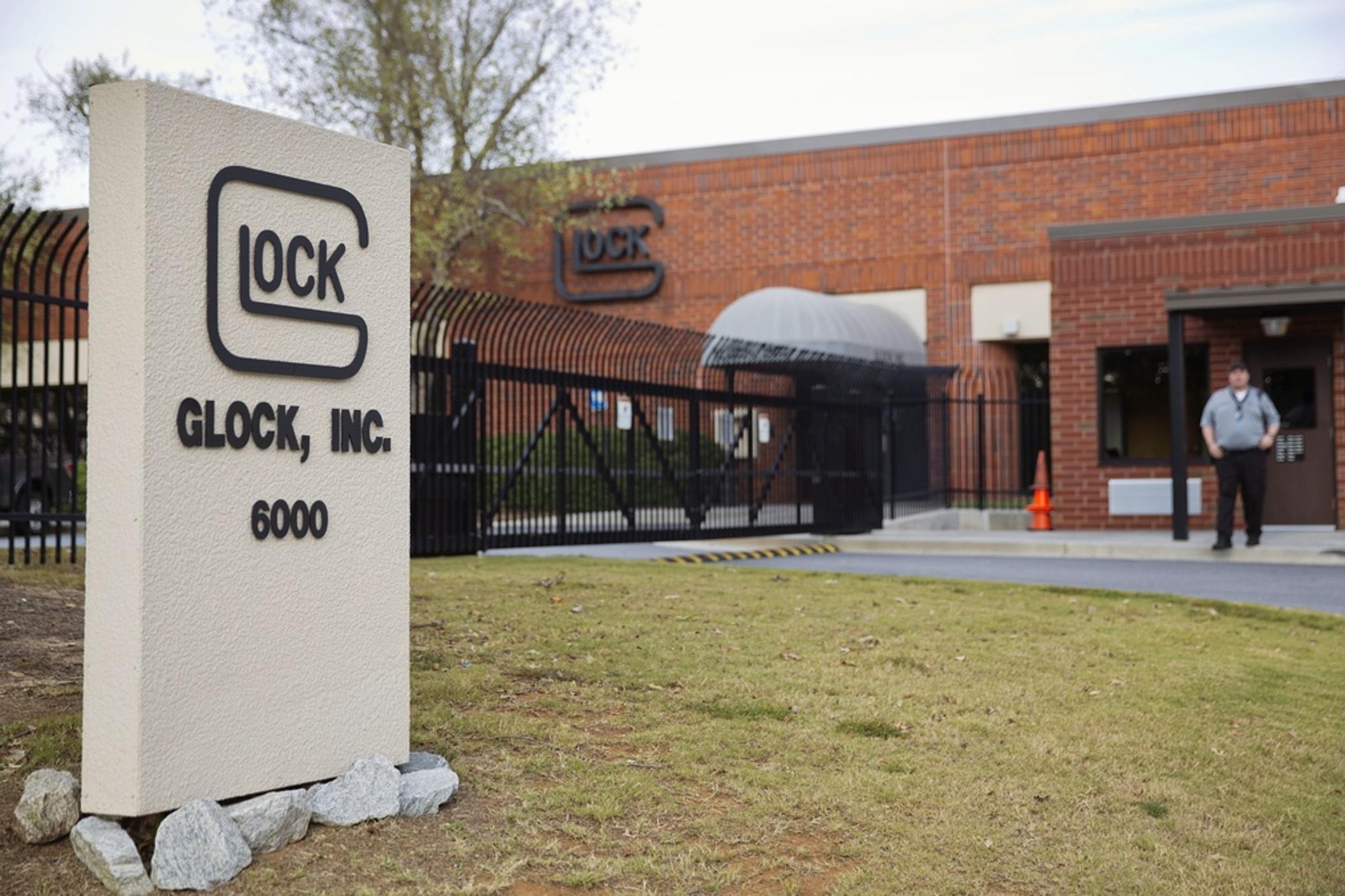 A security guard stands outside the Glock Inc. headquarters, Oct. 8, 2014, in Smyrna, Ga. The city of Chicago sued Glock Inc. on Tuesday, March 19, 2024, alleging the handgun manufacturer is facilitating the proliferation of illegal machine guns that can fire as many as 1,200 rounds per minute on the streets of the city. 