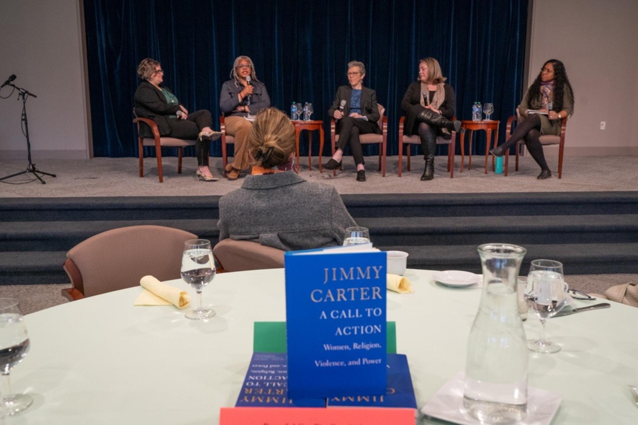 'A Call to Action': Jimmy Carter's 2014 book about women's rights was presented to guests at an International Women's Day event at the Carter Center March 11 celebrating the book's 10th anniversary and women's history month. Event attendees participated in a discussion about actions toward security and equality. Panelists (from left) included some of Jimmy Carter's close advisors (from left): Beth Davis, Meredith Evans, Ph.D., Judy Langford Carter, Lauren Gay and moderator Aklima Khondoker.
