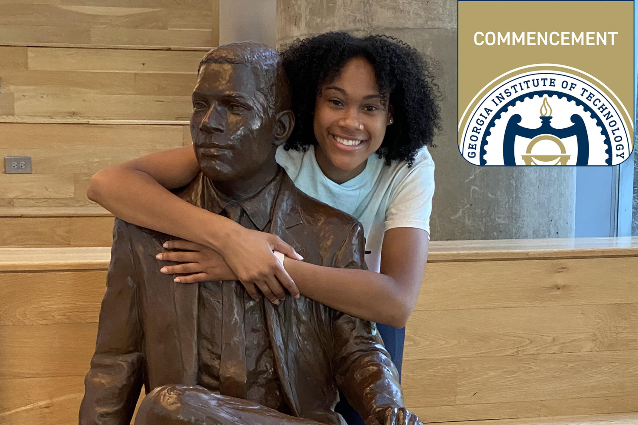 Deanna Yancey poses with a statue of her grandfather, Ronald Yancey, who became the first Black graduate of the university in 1965. Deanna earned her master's degree from Georgia Tech in May 2024.