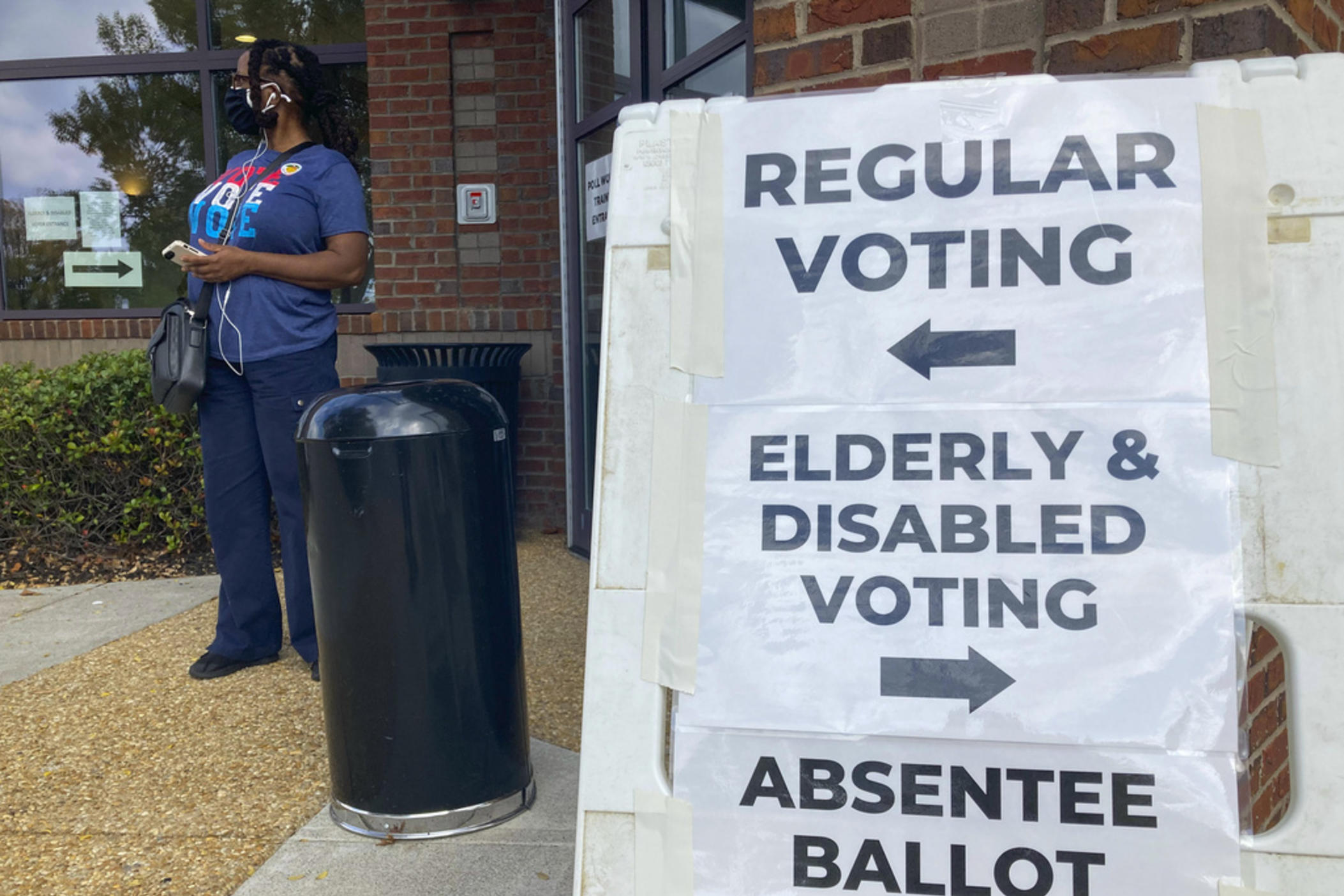 Signs to guide voters are posted outside a Cobb County polling station on the first day of early voting, in Marietta, Ga., Oct. 17, 2022. 