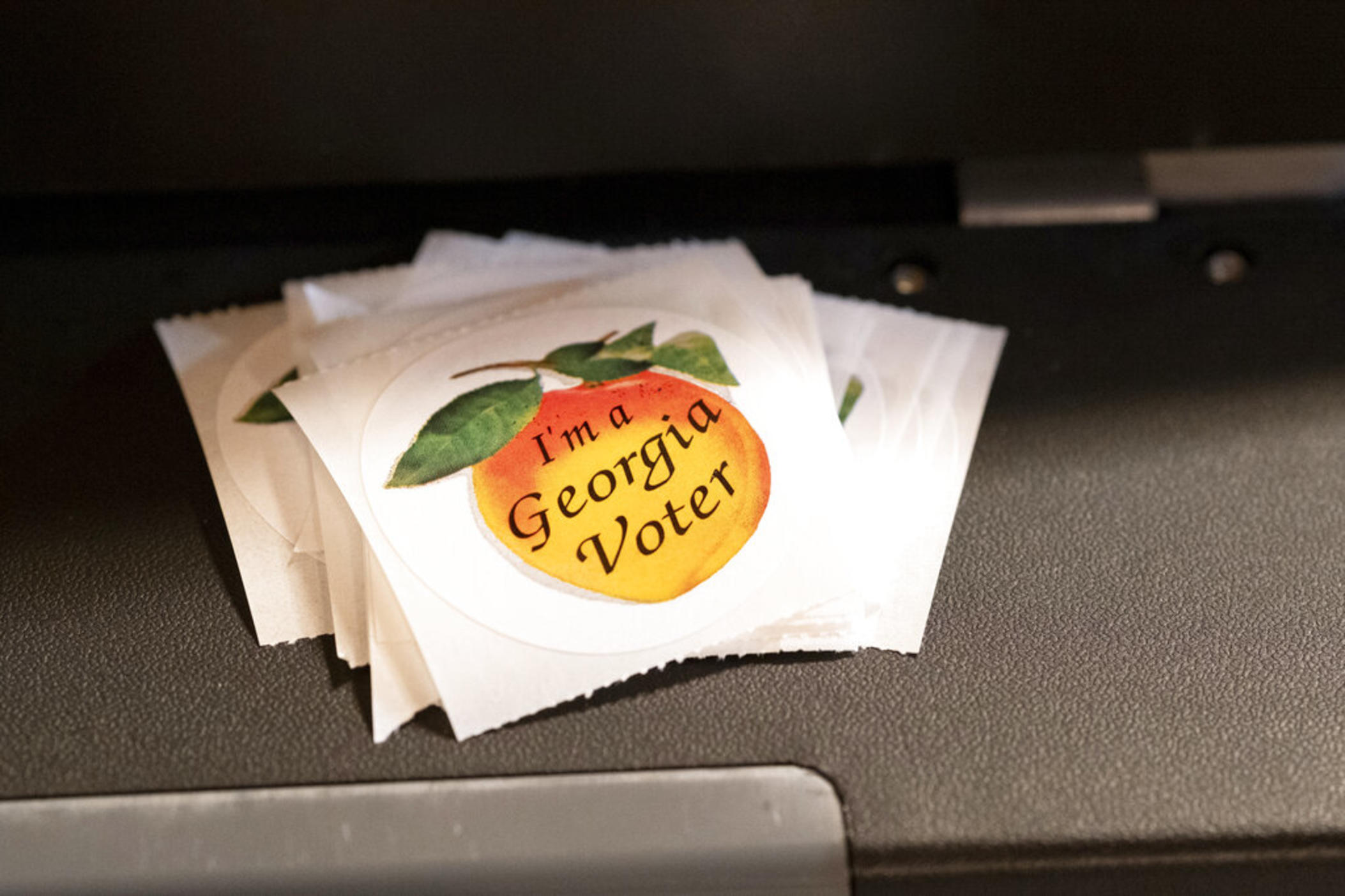 A stack of stickers sits atop the ballot scanner during the mid-term election Tuesday, Nov. 8, 2022 at Lawrenceville Road United Methodist Church in Tucker, Ga. 