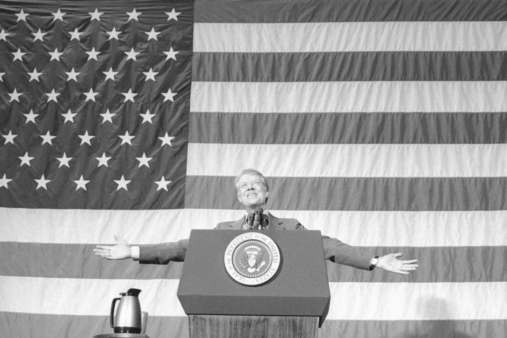 President Jimmy Carter acknowledges the applause of about 1,100 people gathered in the Elk City High School gym for a town meeting in Elk City, Okla., March 24, 1979. 