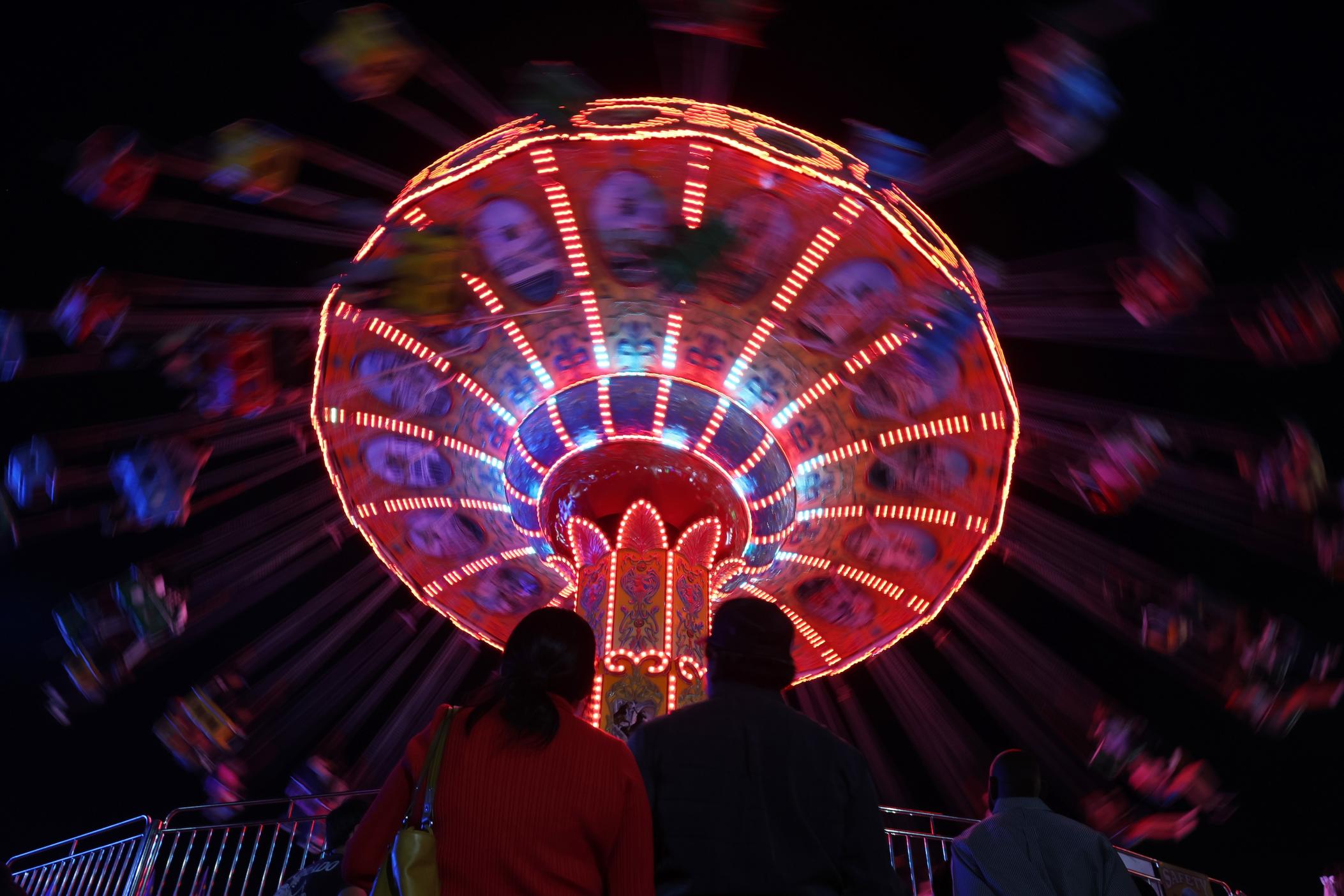 Fair attendees look up at a fair ride during the Georgia National Fair in Perry, Georgia on Saturday, Oct. 5, 2024.(Photo/Avni Trivedi)