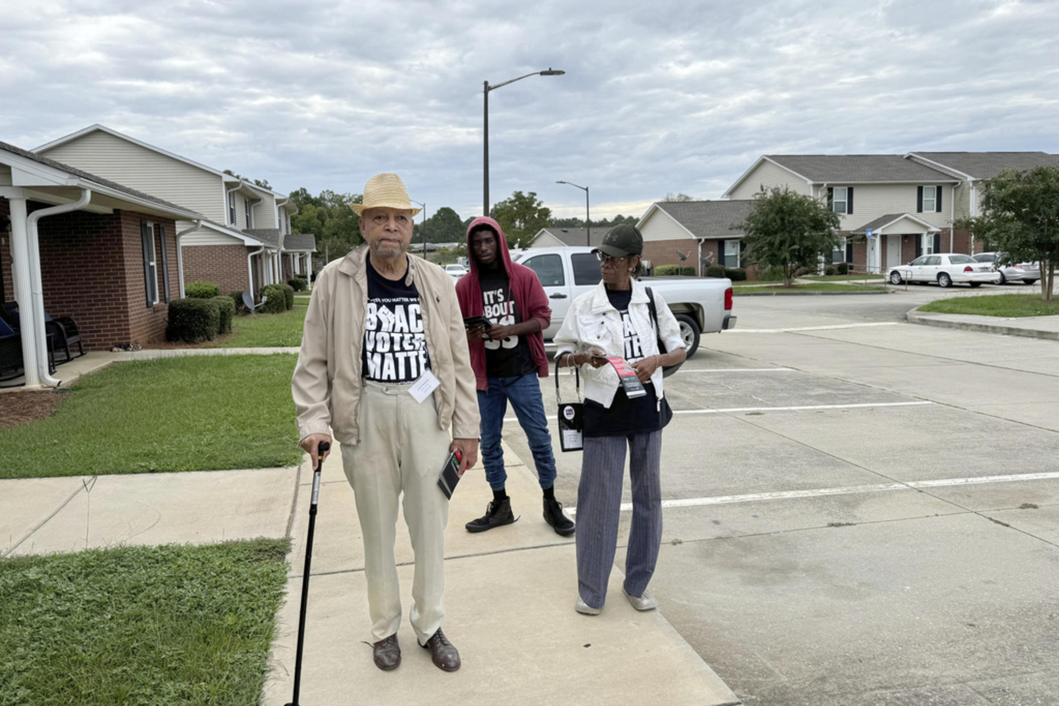 The Rev. Ezekiel Holley, Delvin Blackwell, and Patricia Powell walk through a neighborhood to knock on doors to get out the vote in Georgia's Terrell County on Oct. 5, 2024. 