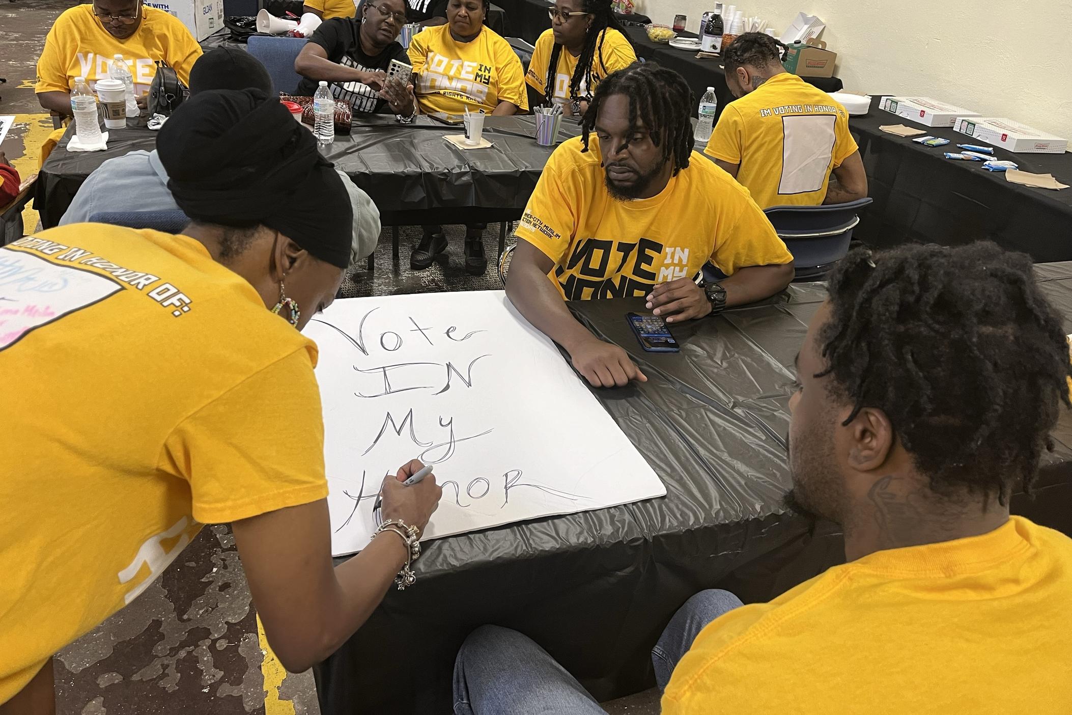 Canvassers with Inner-City Muslim Action Network Atlanta make a poster before canvassing in Augusta on September 15, 2024