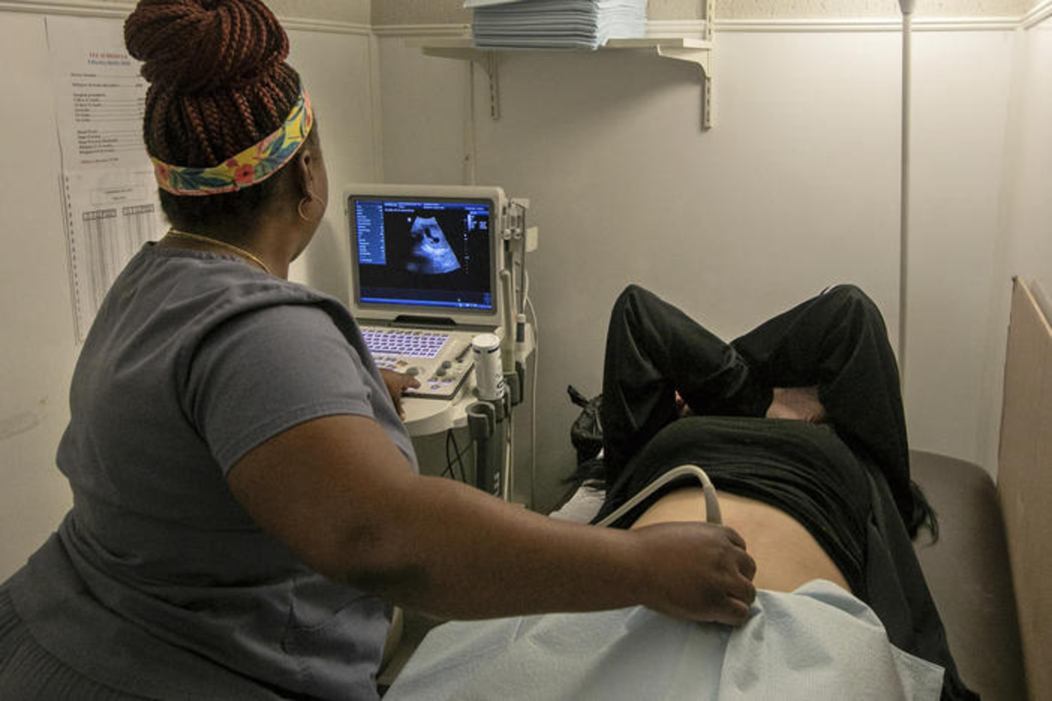 An operating room technician performs an ultrasound on a patient in Louisiana on July 6, 2022.
