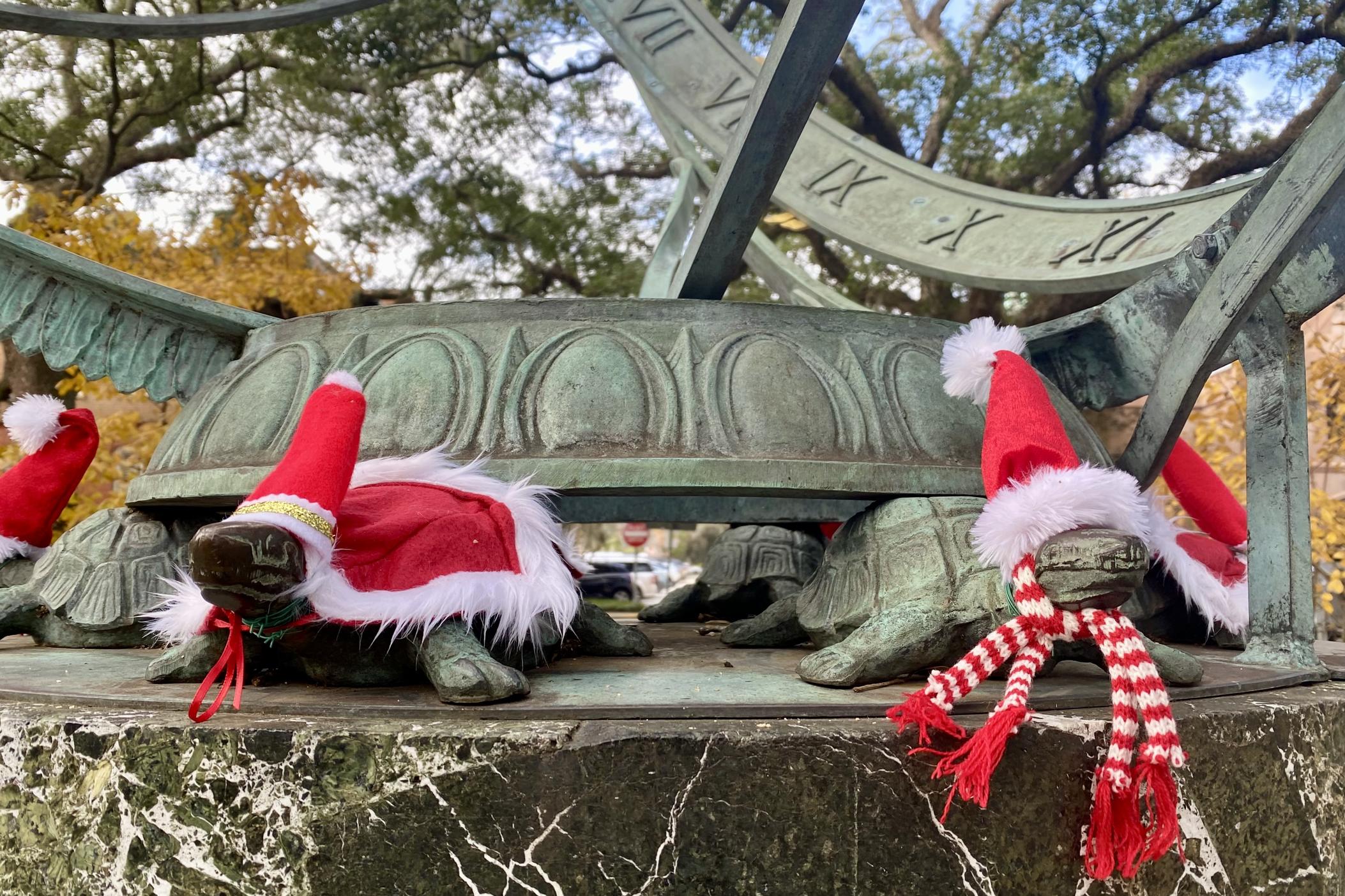 During Christmastime, the turtle sculptures in downtown Savannah's Troup Square are dressed in Santa Claus hats.