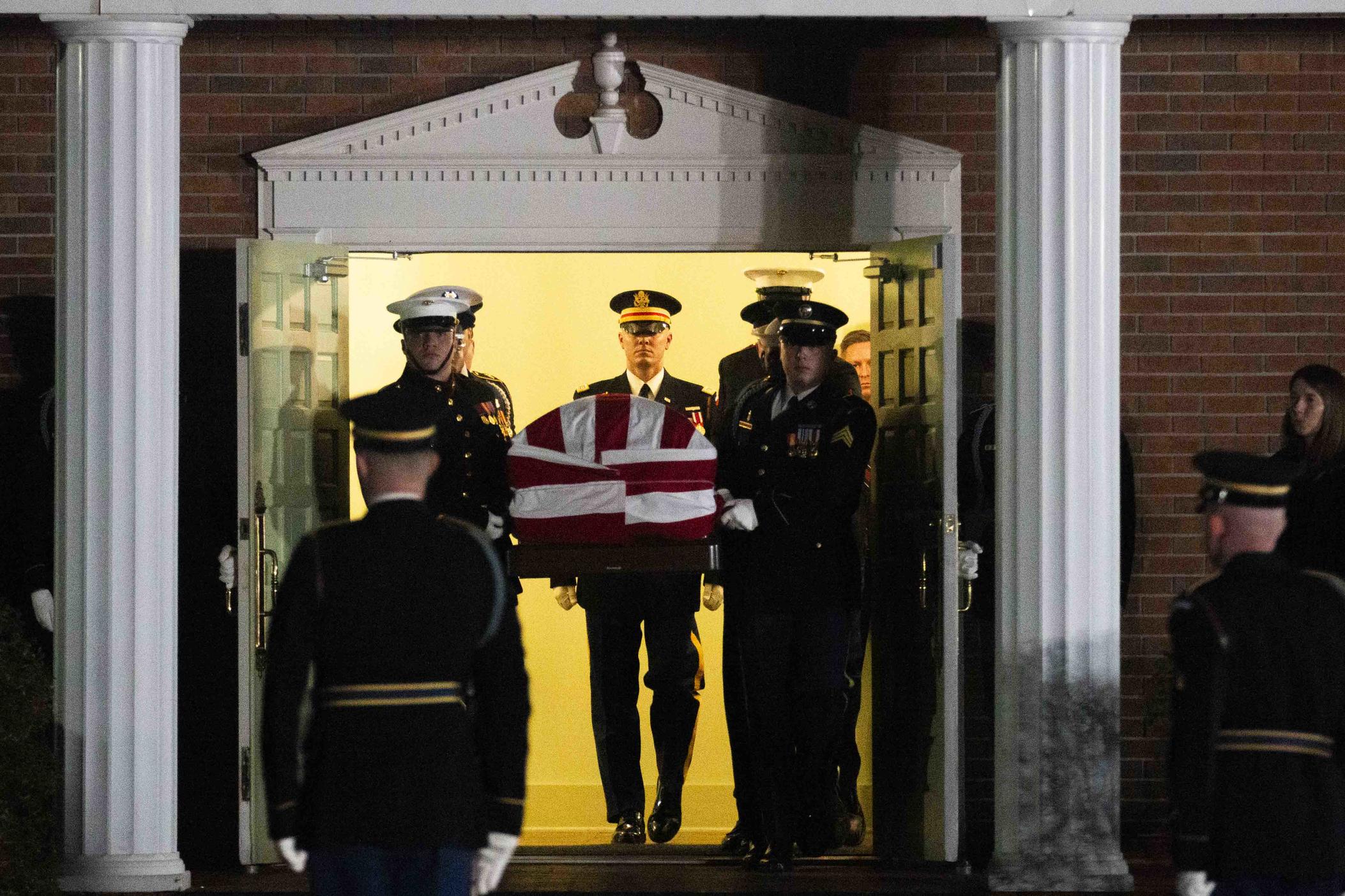A military honor guard carries the casket carrying former president Jimmy Carter out of his home church Maranatha Baptist Church in Plains, Ga. after his final funeral Thursday.