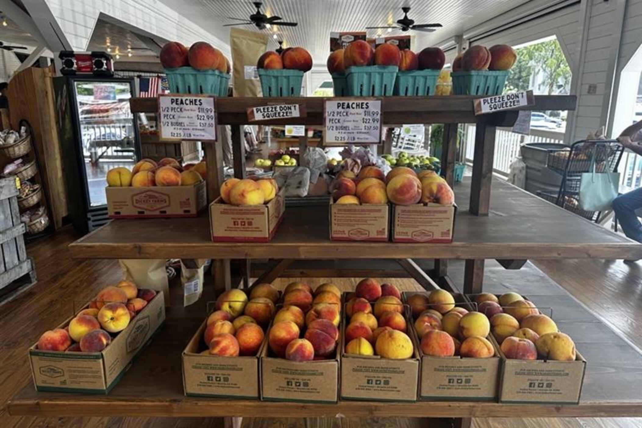 Peaches sit in boxes on a shelf at Dickey Farms.
