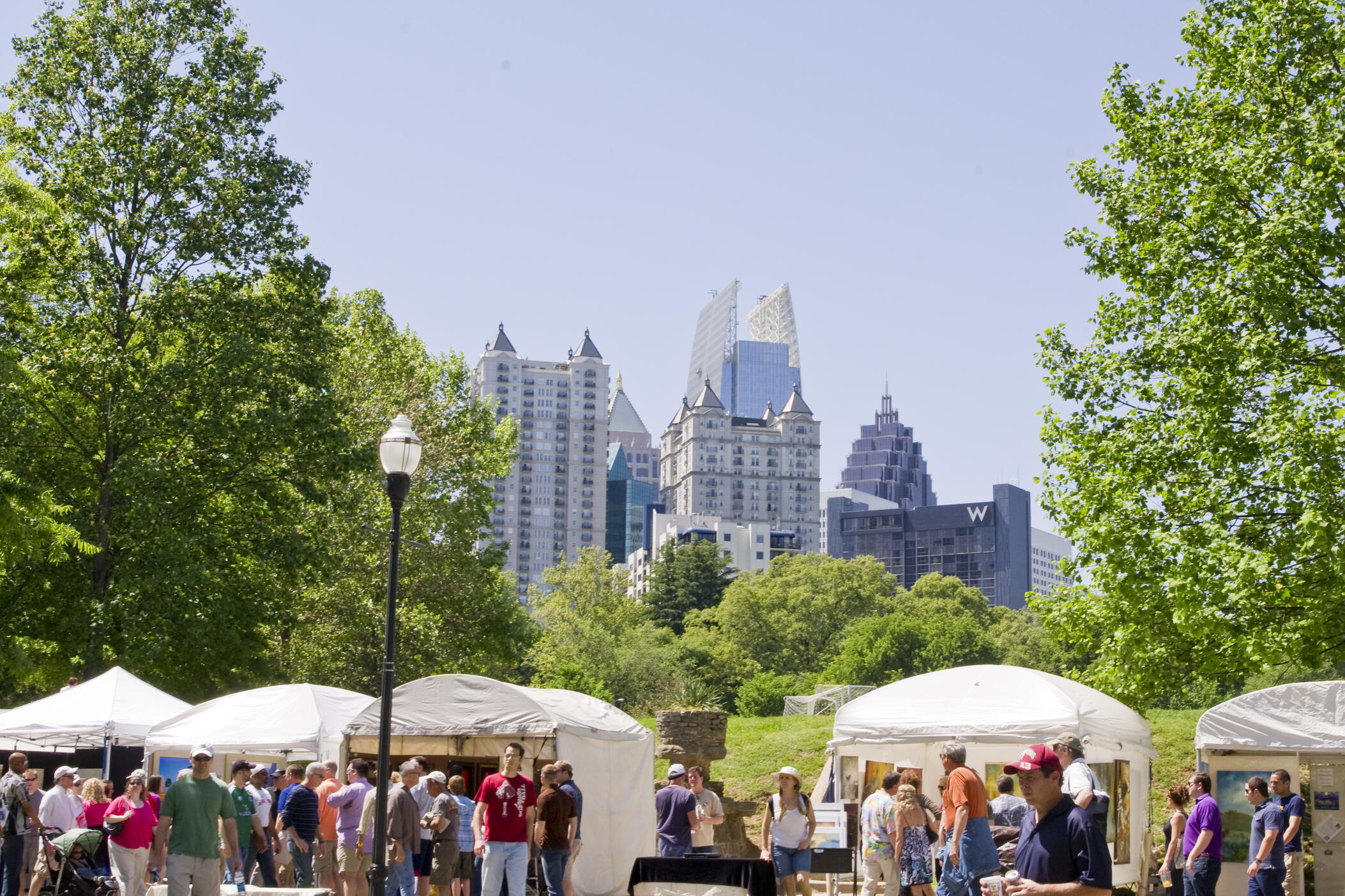 Attendees visit tents at the Atlanta Dogwood Festival at Piedmont Park.