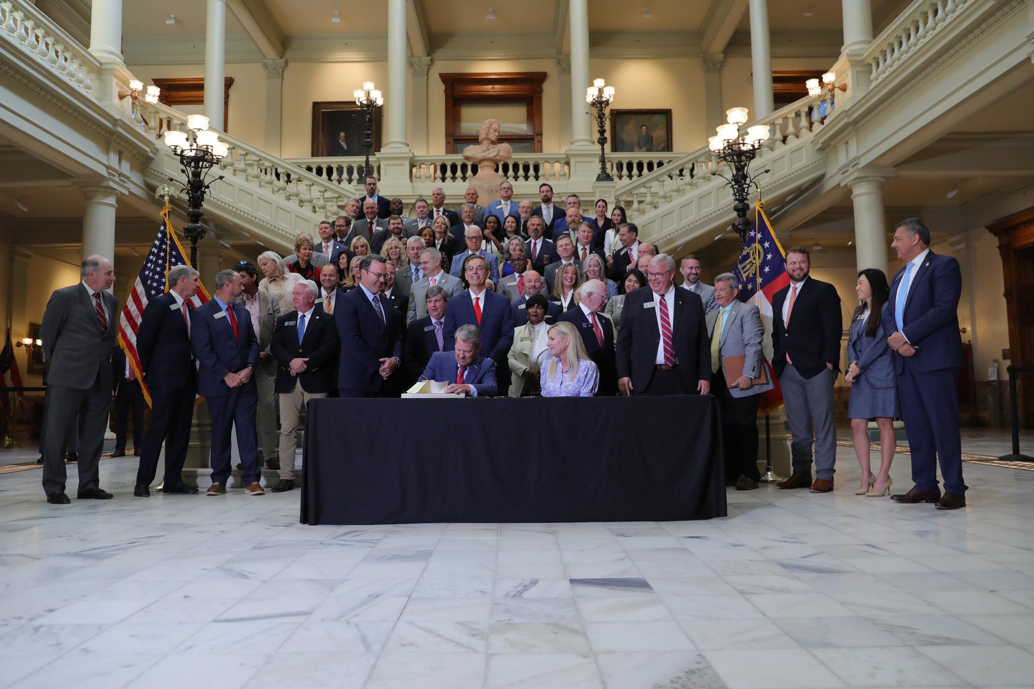 Gov. Brian Kemp signs bills into law inside the Georgia Capitol on May 8, 2025. Rep. Beth Camp is pictured among the lawmakers in attendance.