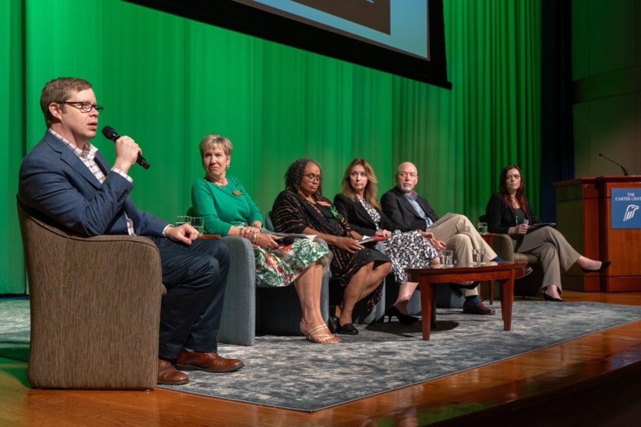 Josh Carter (left) speaks at the Carter Center Mental Health Forum, along with Carter Center leadership on May 20, 2025. 