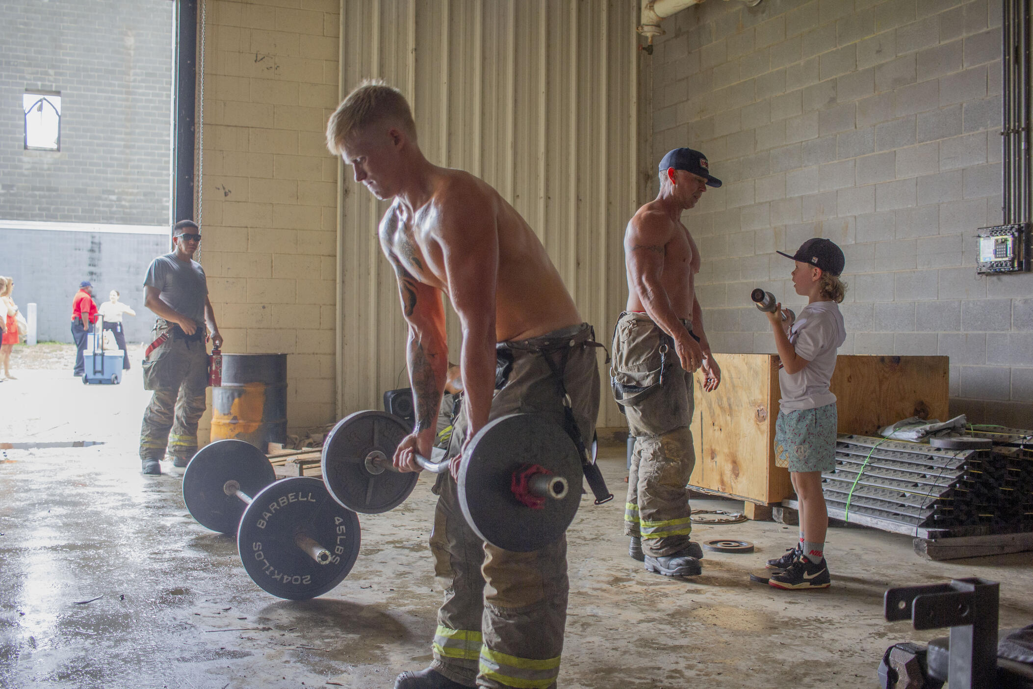 Macon-Bibb County firefighters lift weights in preparation for a photoshoot on June 4, 2025 for the Middle Georgia Firefighter Calendar.