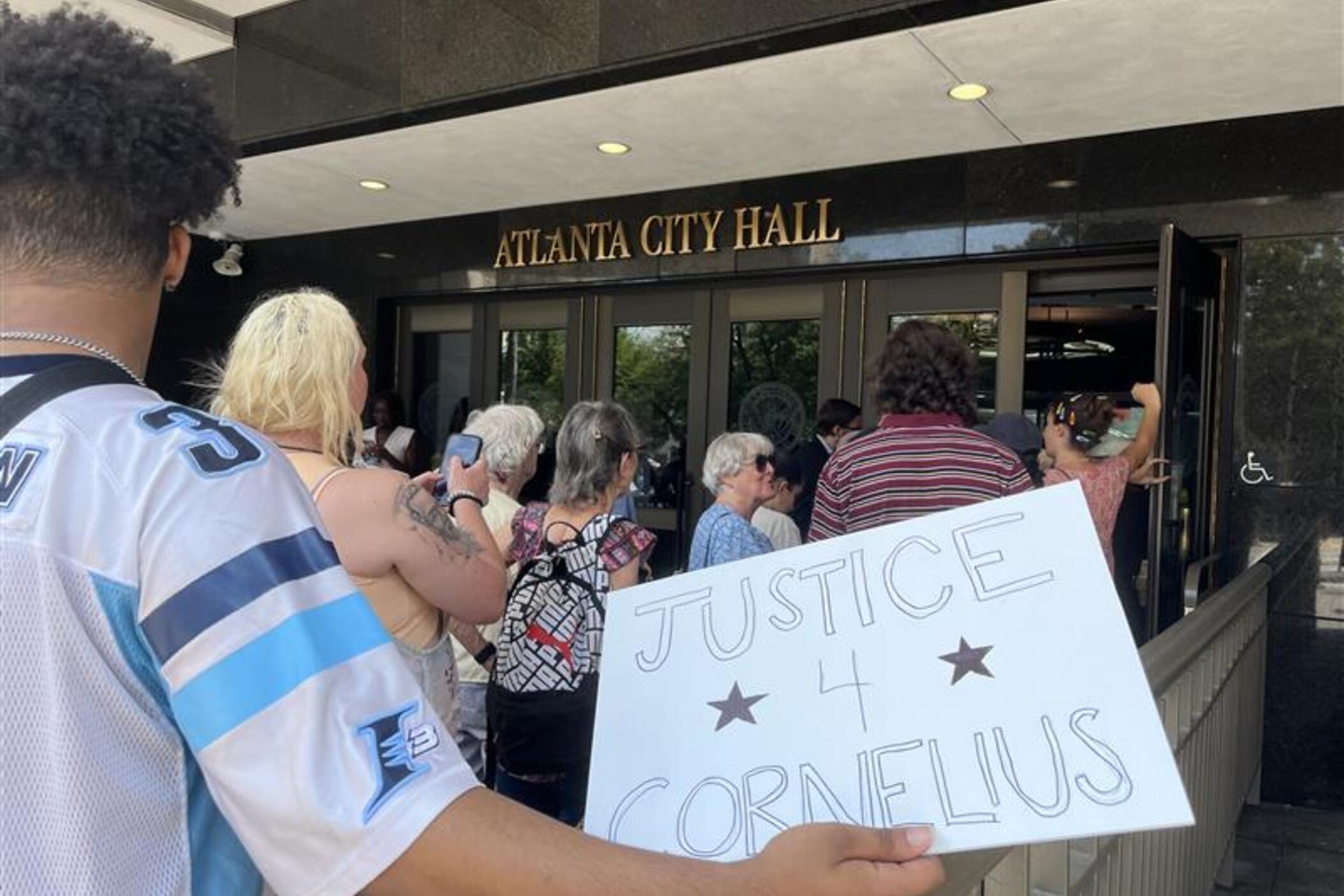 sign reads" justice 4 Cornelius" at Atlanta City Hall