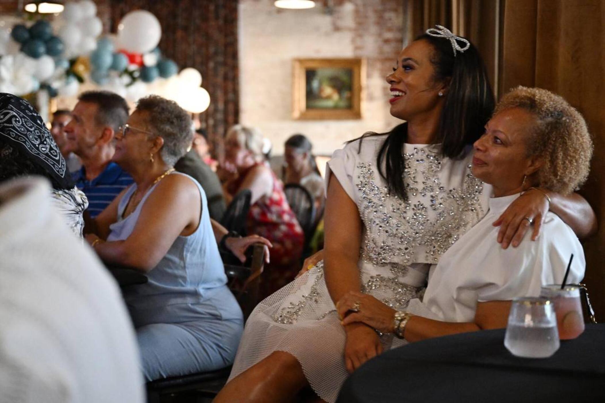 Her Majesty Kitchen owner Chelsia Green Ogletree sits with her aunt Melanie Green Fowler while watching her appearance on the Food Network competition show “Chopped” on Tuesday, July 8, 2025, at Her Majesty Kitchen in Forsyth, Georgia. Ogletree won the competition out of four chefs from across the country and a $10,000 prize. 