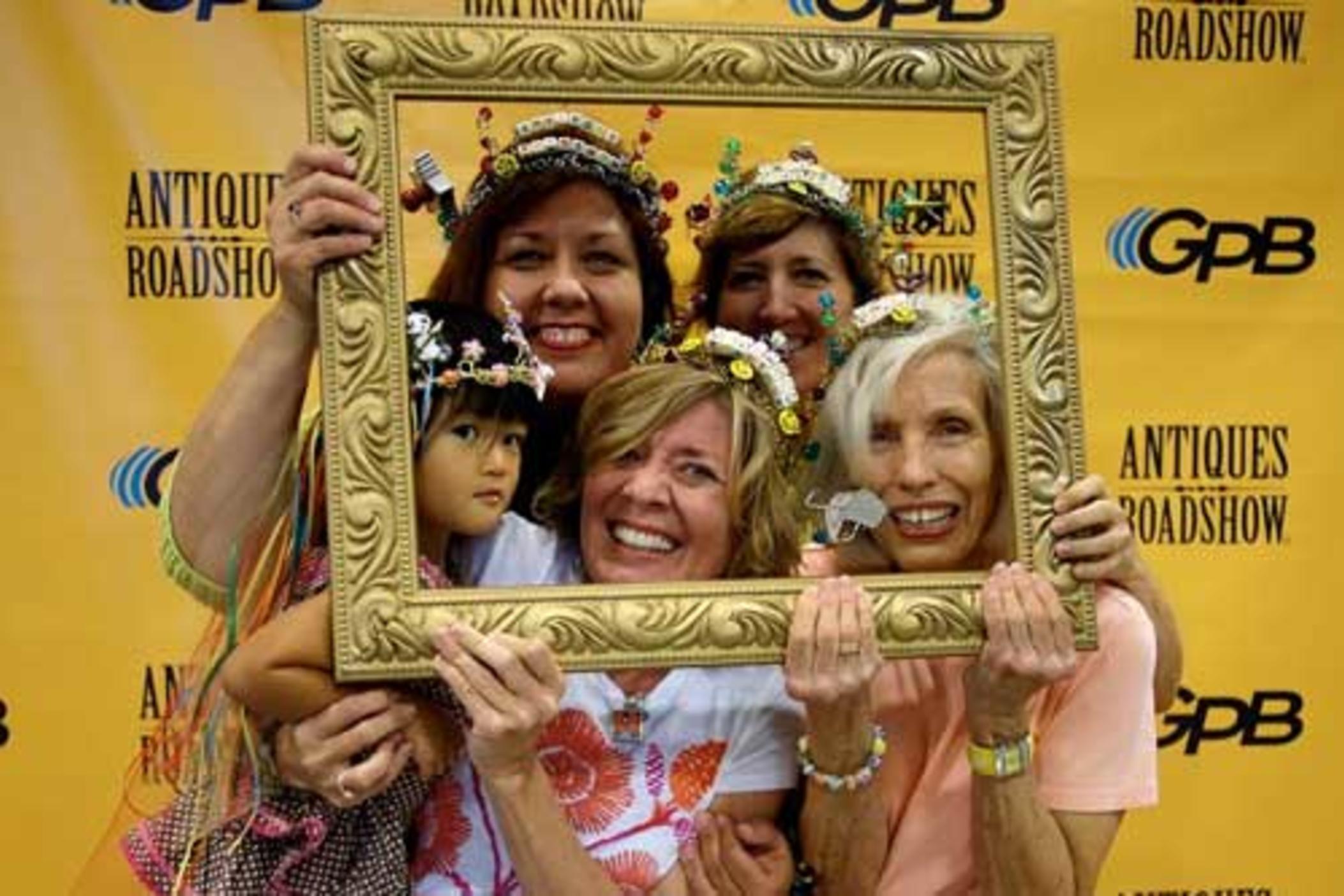 Happy families at Antiques Roadshow taping, even though their treasure wasn't worth much.