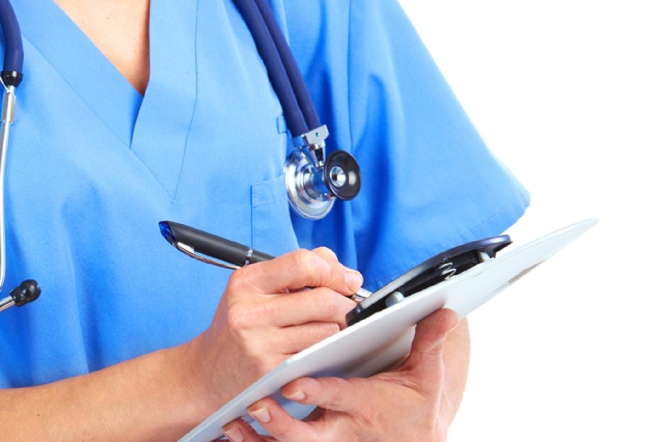 A medical practitioner holds a clipboard.