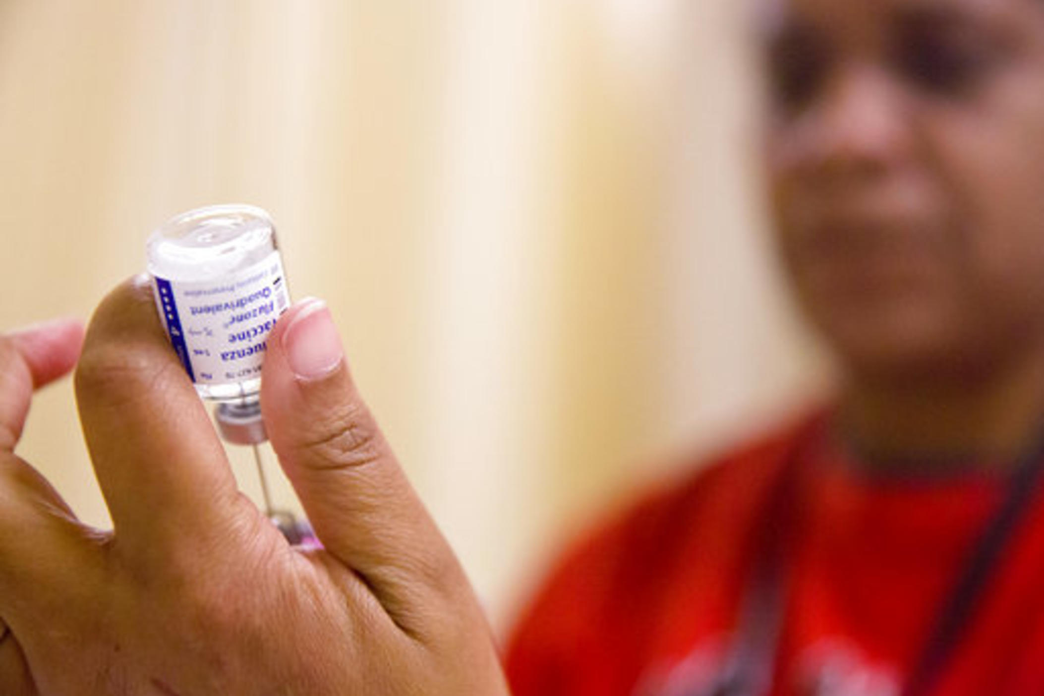A nurse prepares a flu shot from a vaccine vial at the Salvation Army in Atlanta.