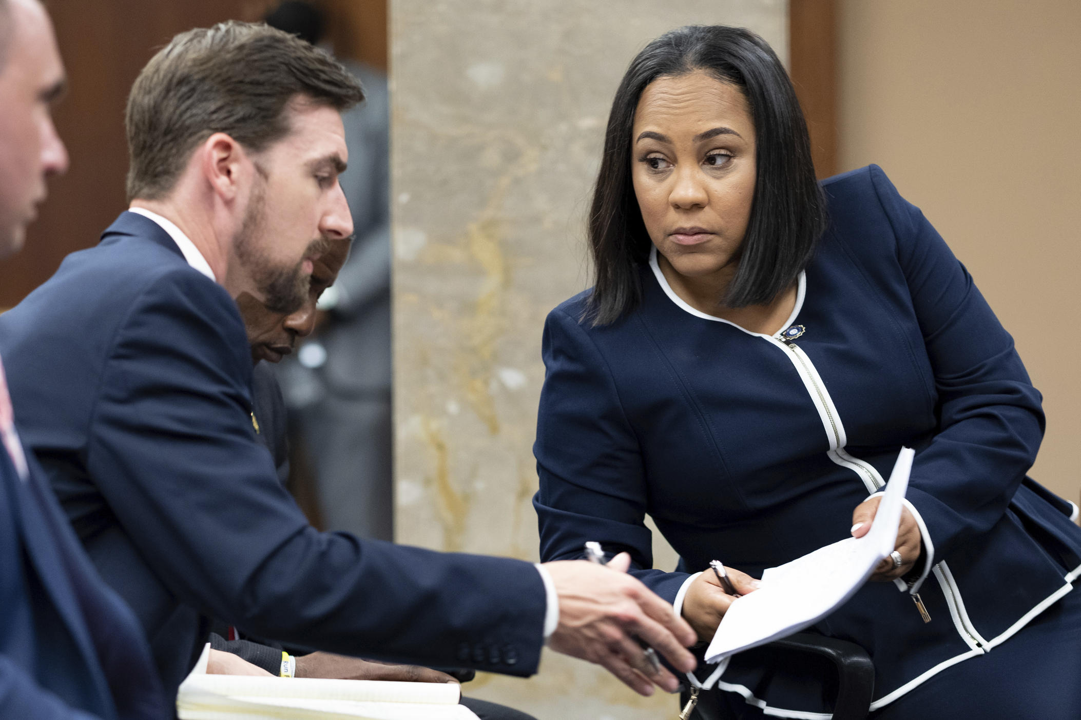 Fulton County District Attorney Fani Willis, right, talks with a member of her team during proceedings to seat a special purpose grand jury in Fulton County, Ga.