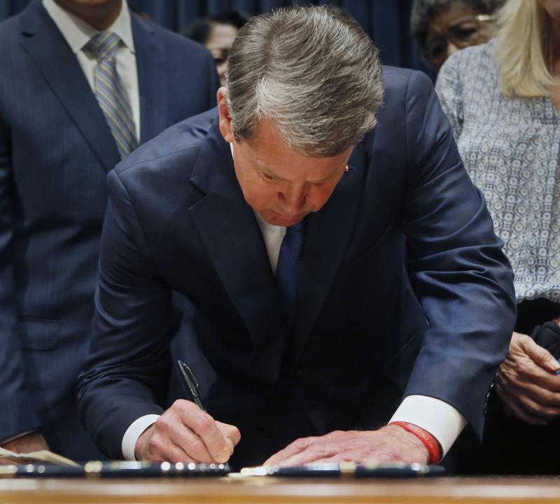 Surrounded by supporters, Gov. Brian Kemp signs House Bill 481, the "heartbeat bill," setting the stage for a legal battle as the state attempts to outlaw most abortions after about six weeks of pregnancy. 