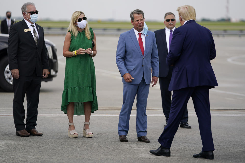 Georgia Governor Brian Kemp greets President Trump at the airport in Atlanta