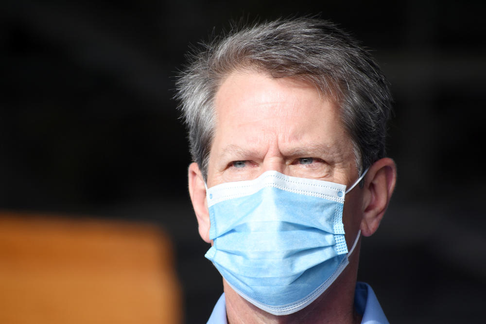 Gov. Brian Kemp wears a mask.