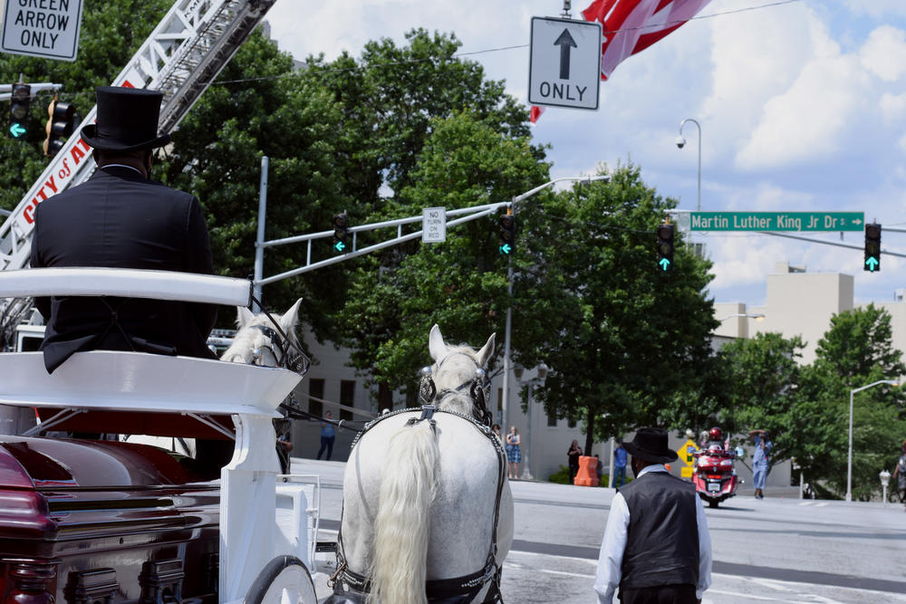 The casket of C.T. Vivian travels through downtown Atlanta on the way to the Martin Luther King, Jr. National Park.