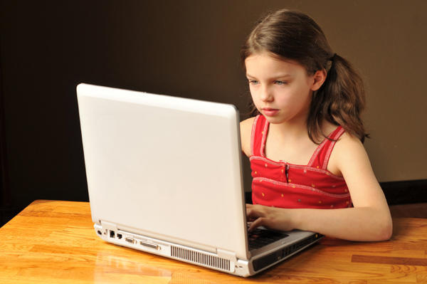 Girl sitting at computer.